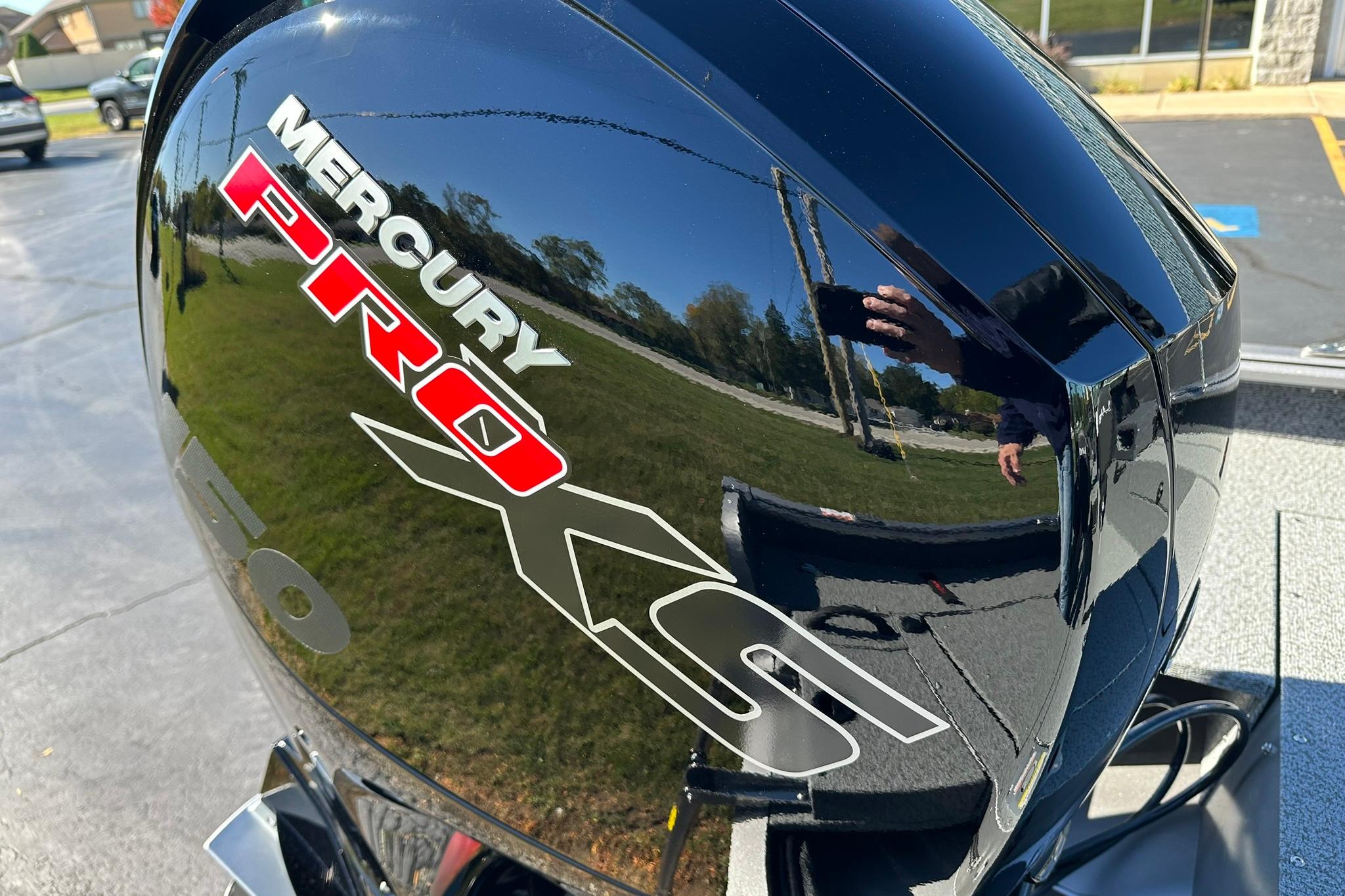 Mercury Pro XS engine on 2026 Lund 1875 Impact XS Sport boat, reflecting surroundings.