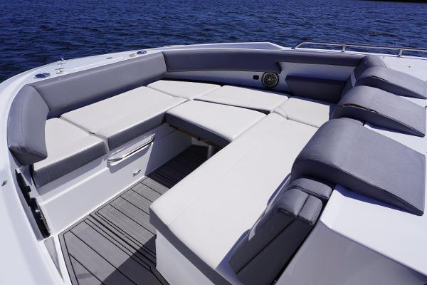 Luxurious seating area on 2020 Cruisers Yachts 38 GLS OB, overlooking serene blue waters.