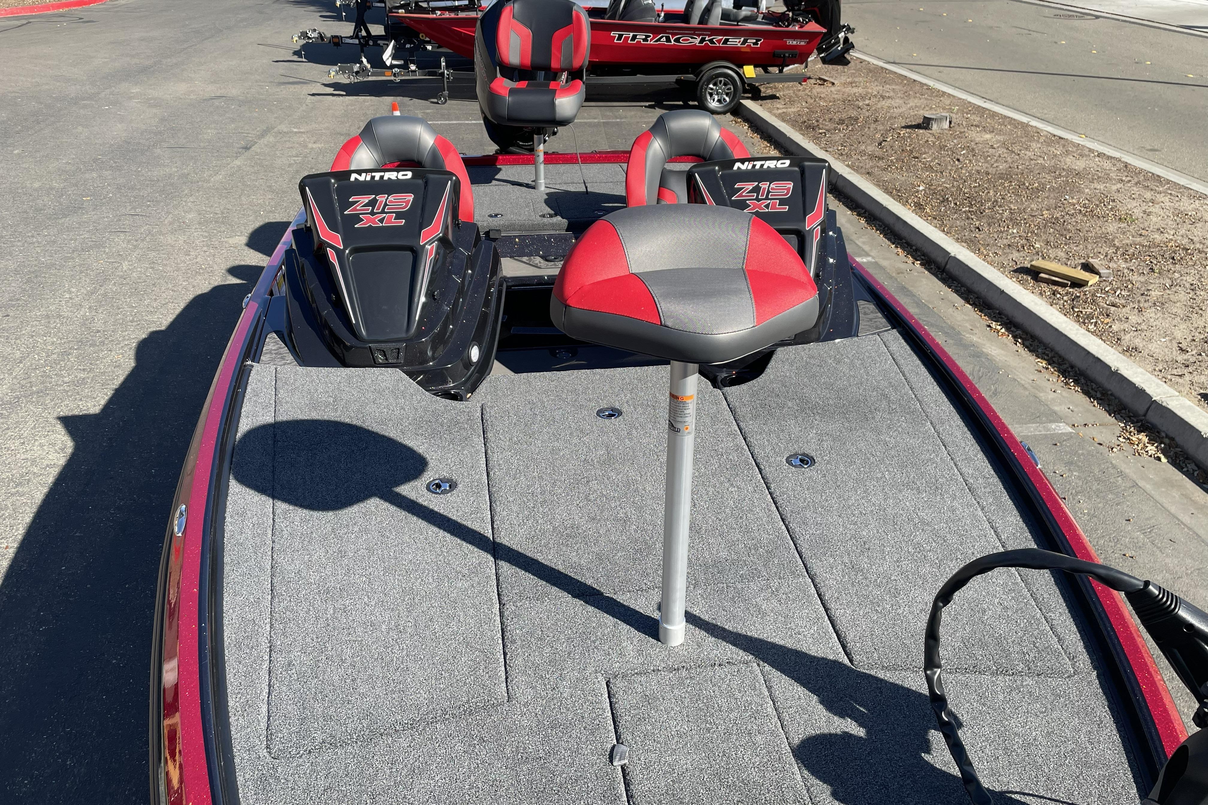 2026 Nitro Z19 XL boat with red and gray seating on a sunny day.
