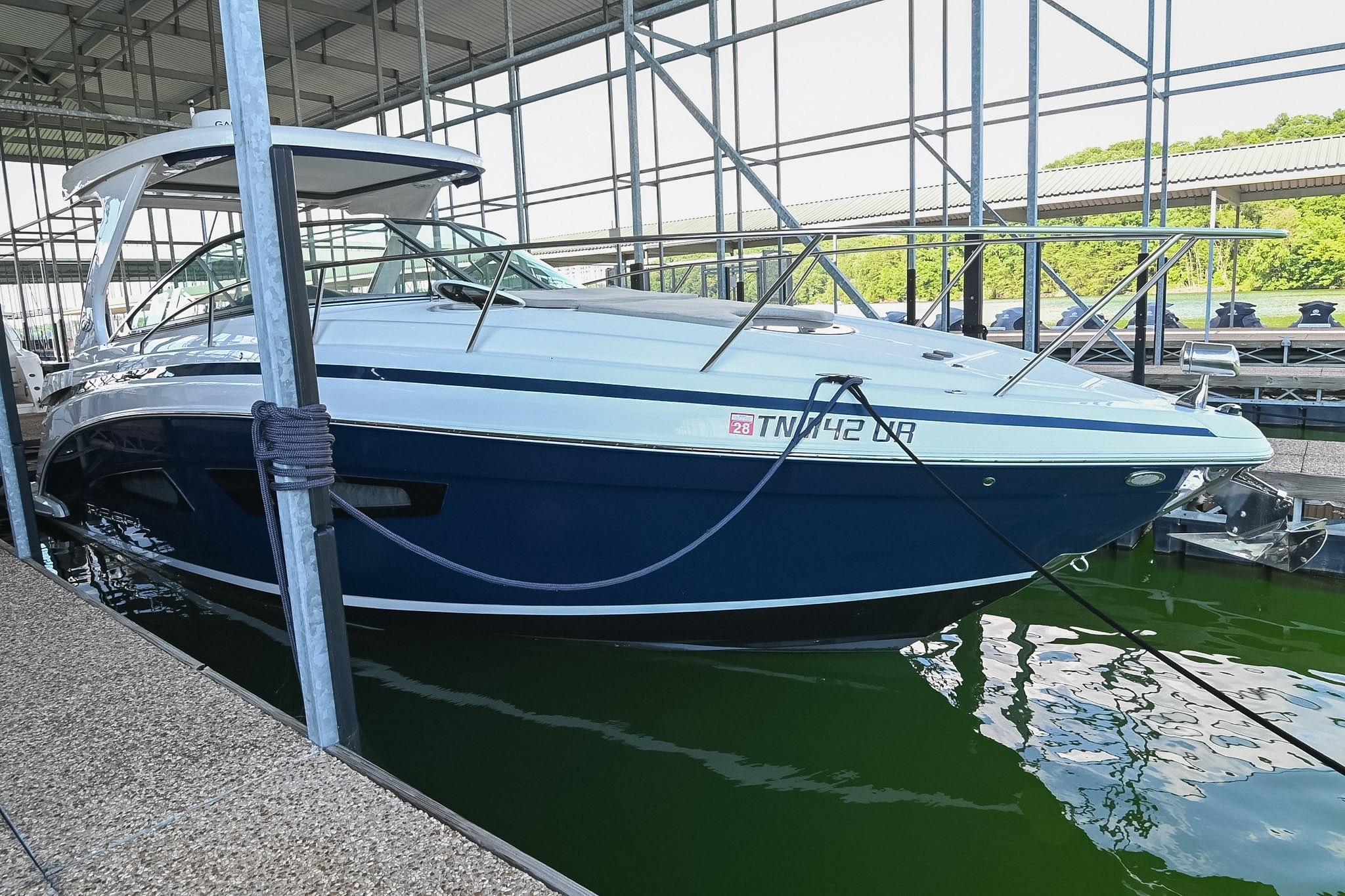 2021 Regal 33 Express boat docked in a marina, featuring sleek design and modern amenities.