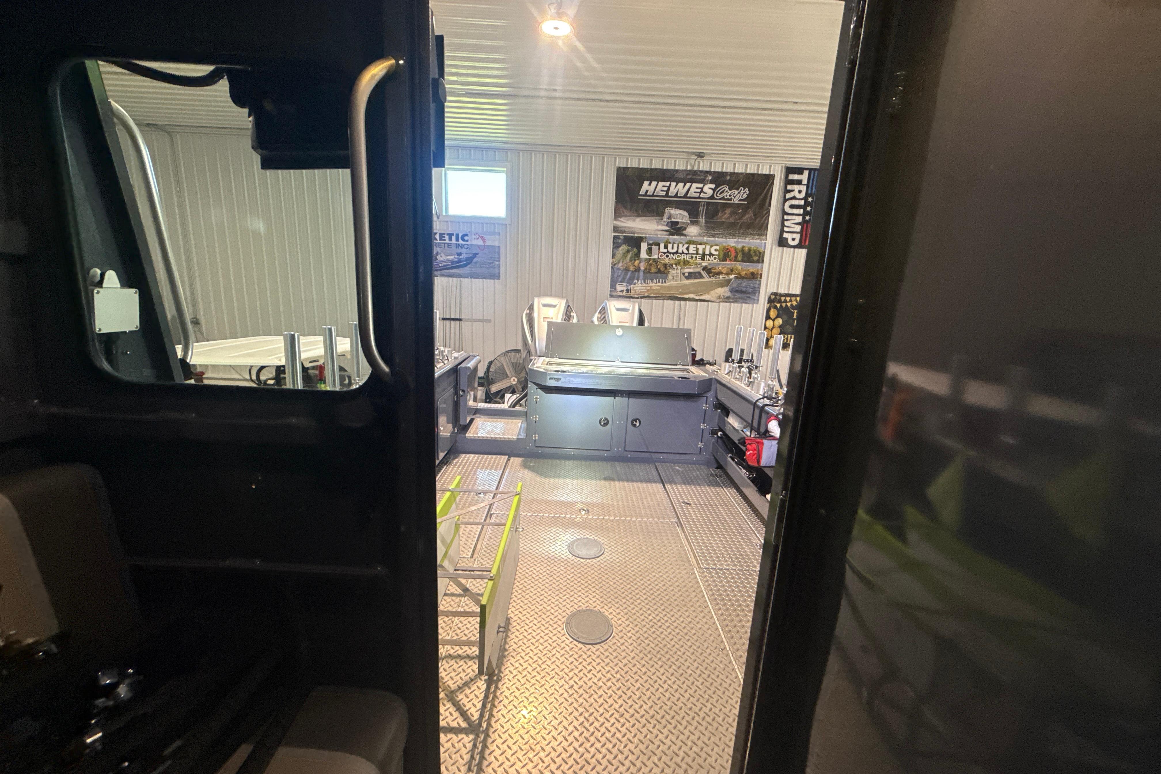 Interior view of 2022 Hewescraft 270 Alaskan Hardtop in a workshop setting.
