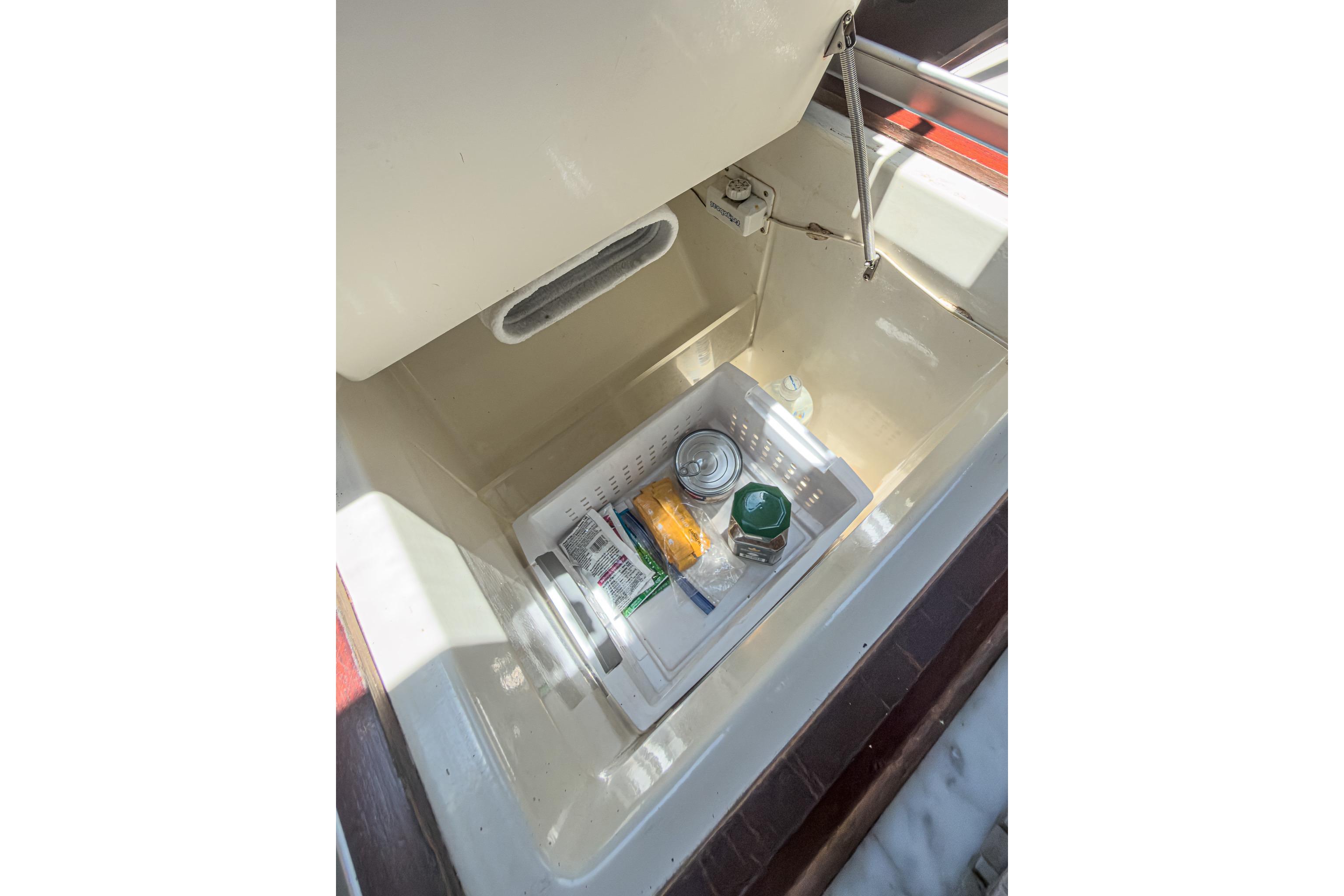 Storage compartment with food items on a 1993 Beneteau First 38 s5 yacht.