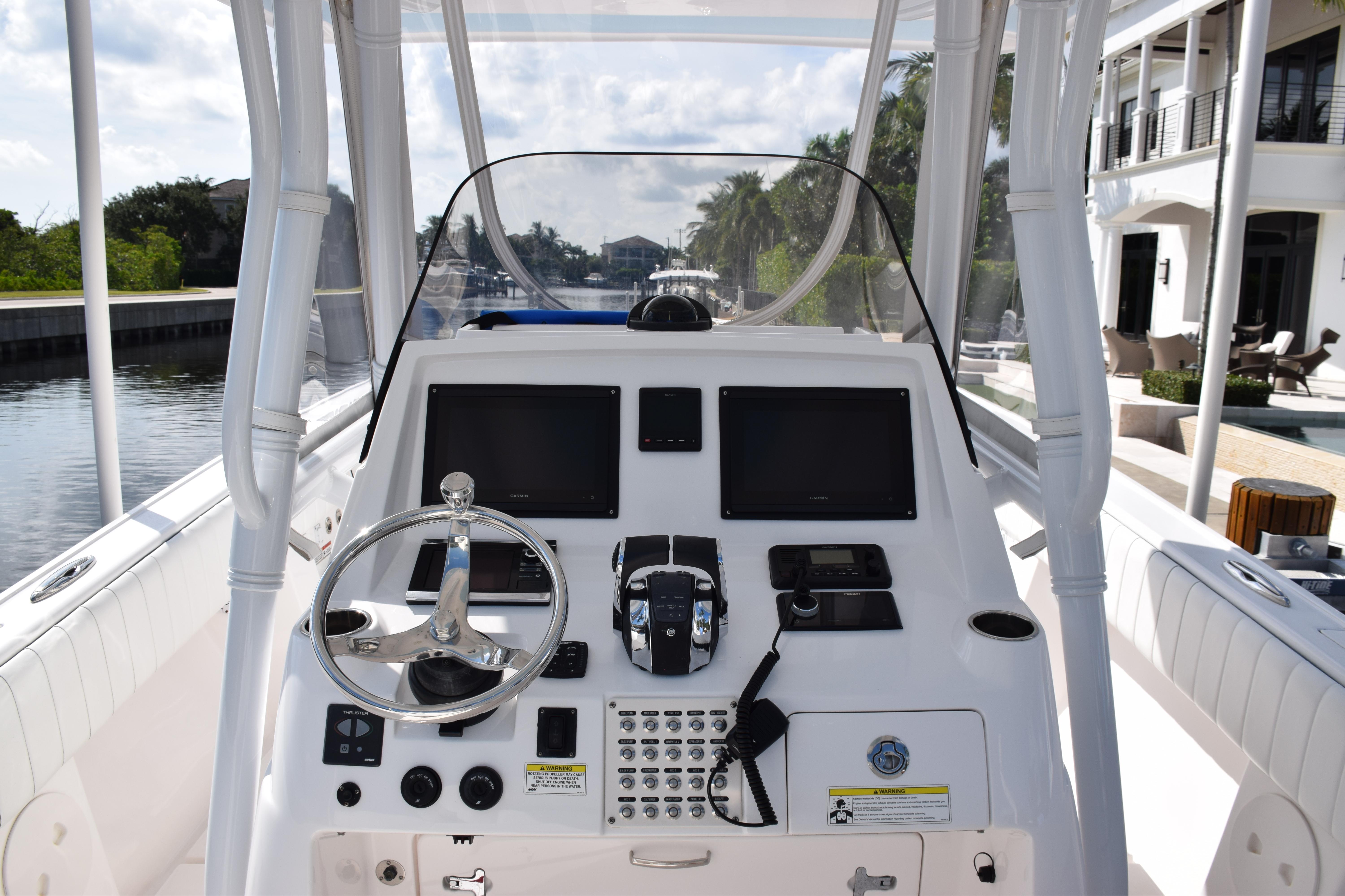 2017 Intrepid 327 boat dashboard with steering wheel and navigation controls.