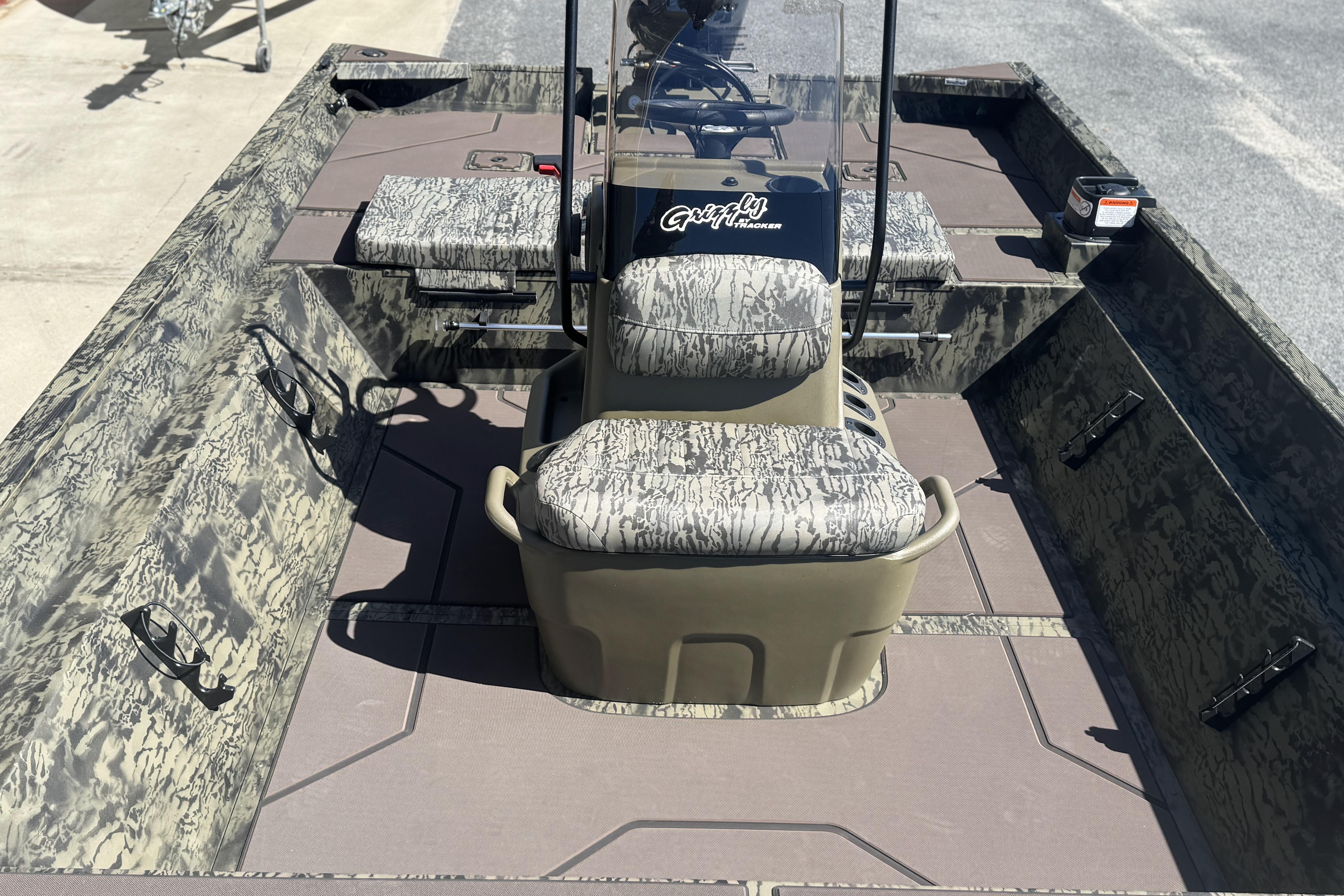 2026 Tracker Grizzly 2072 CC boat interior with camouflage seating and console.