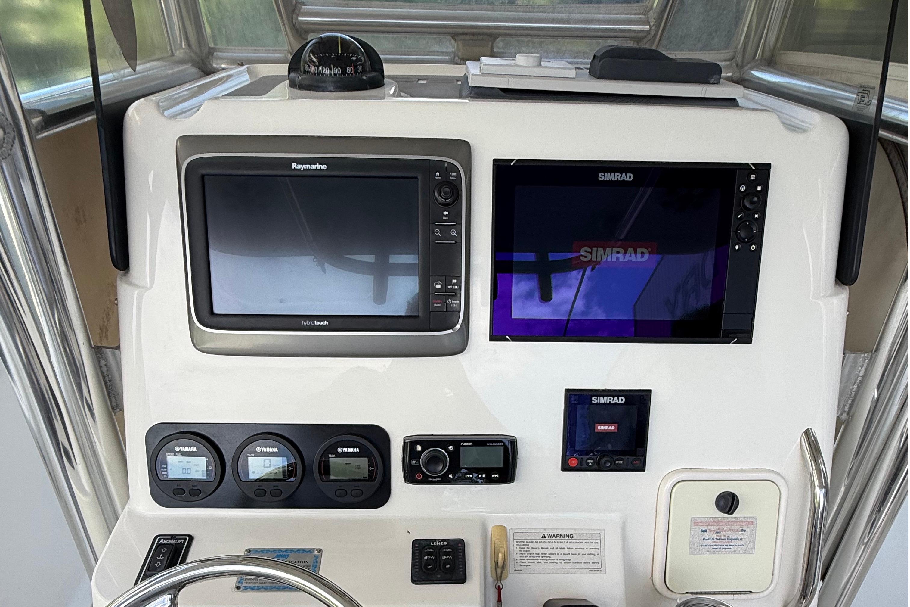 2008 Century 2901 Center Console dashboard with Raymarine and Simrad navigation systems.