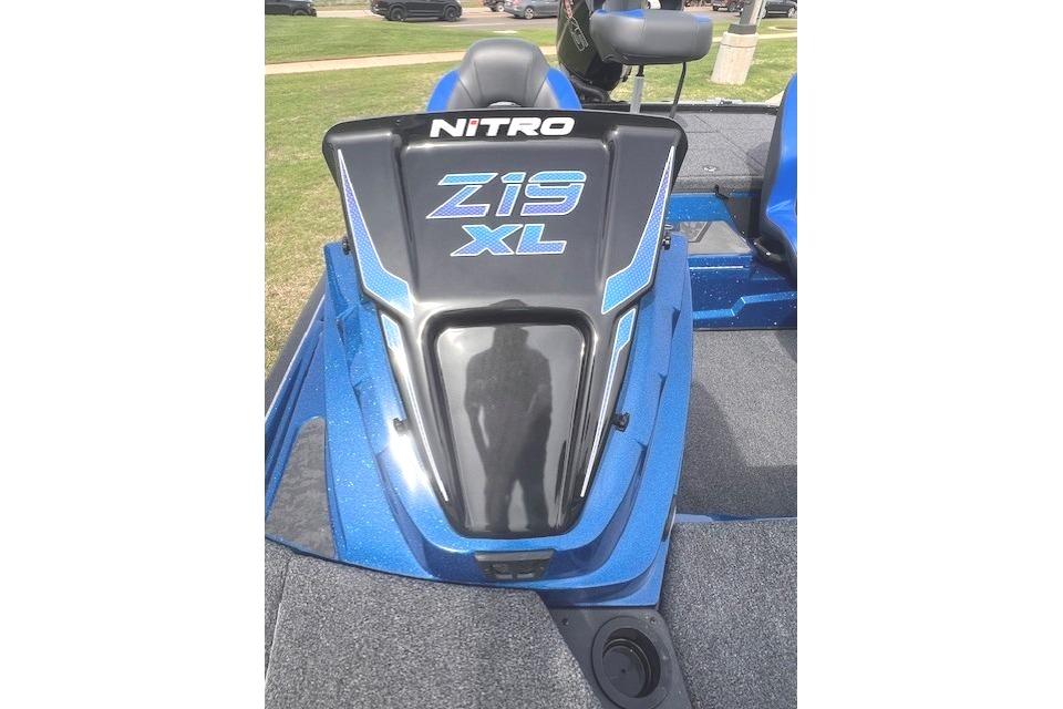 2026 Nitro Z19 XL boat, blue and black design, parked on grass.