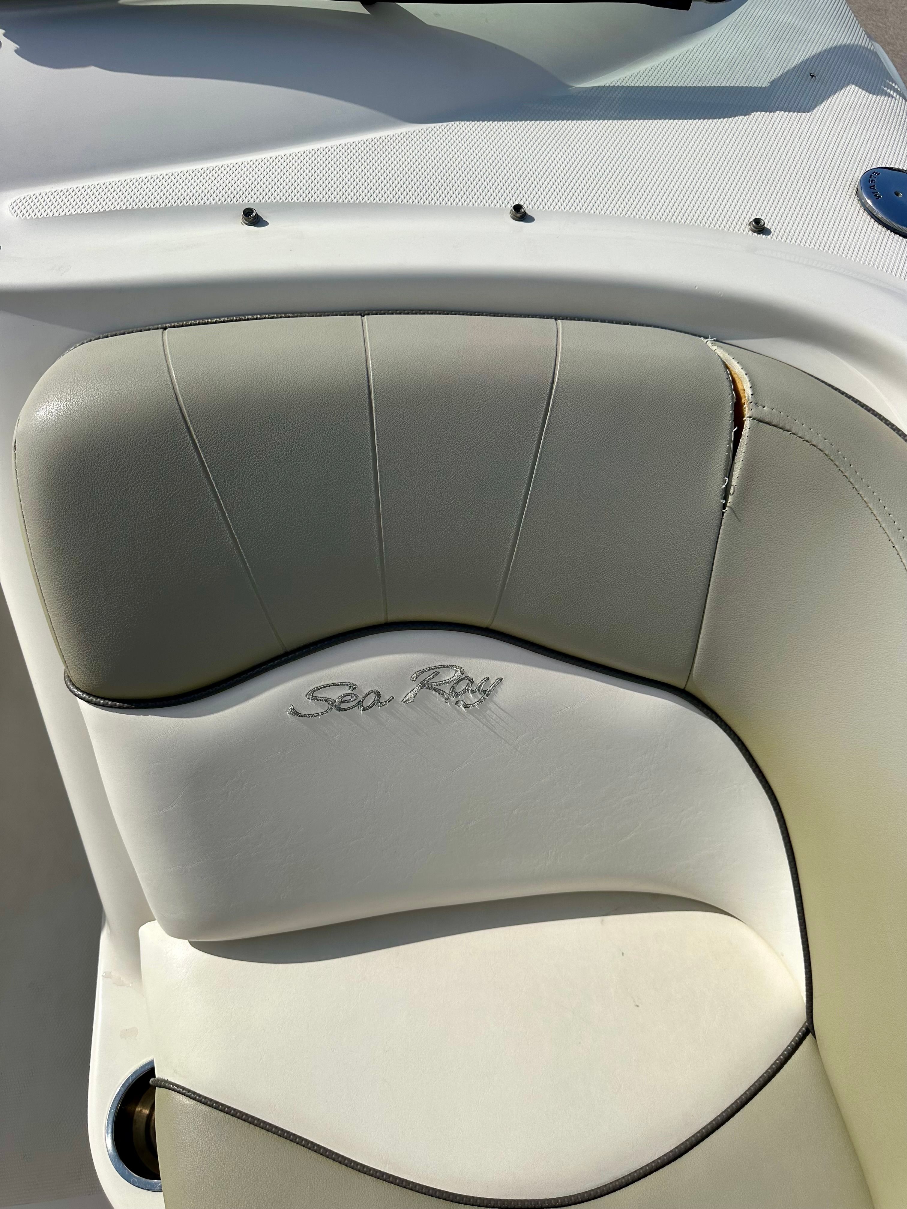 Sea Ray 240 Sundeck 2006 seat upholstery with logo, slight wear visible.