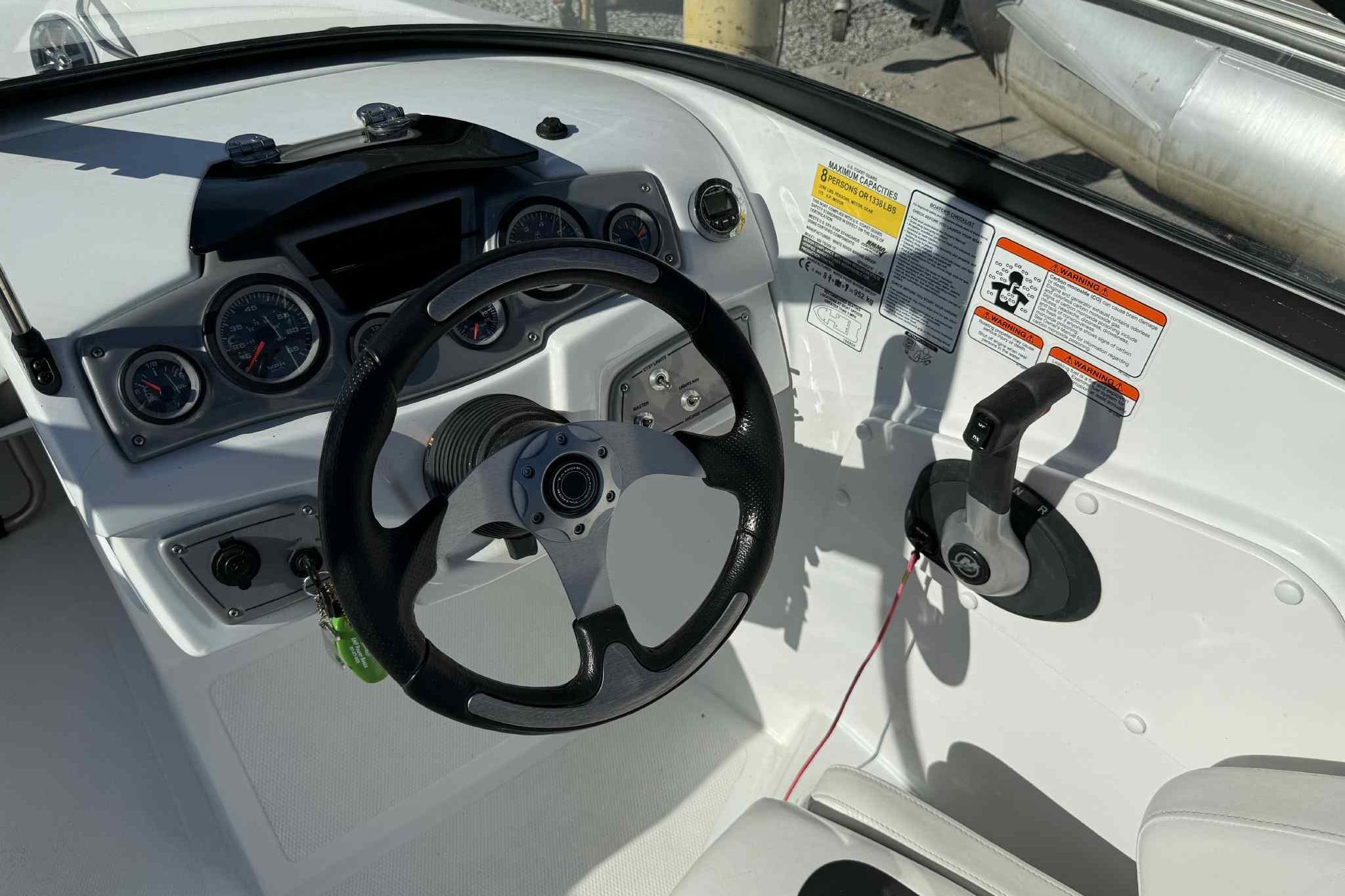 2021 Tahoe 550 TS boat dashboard with steering wheel and control panel.