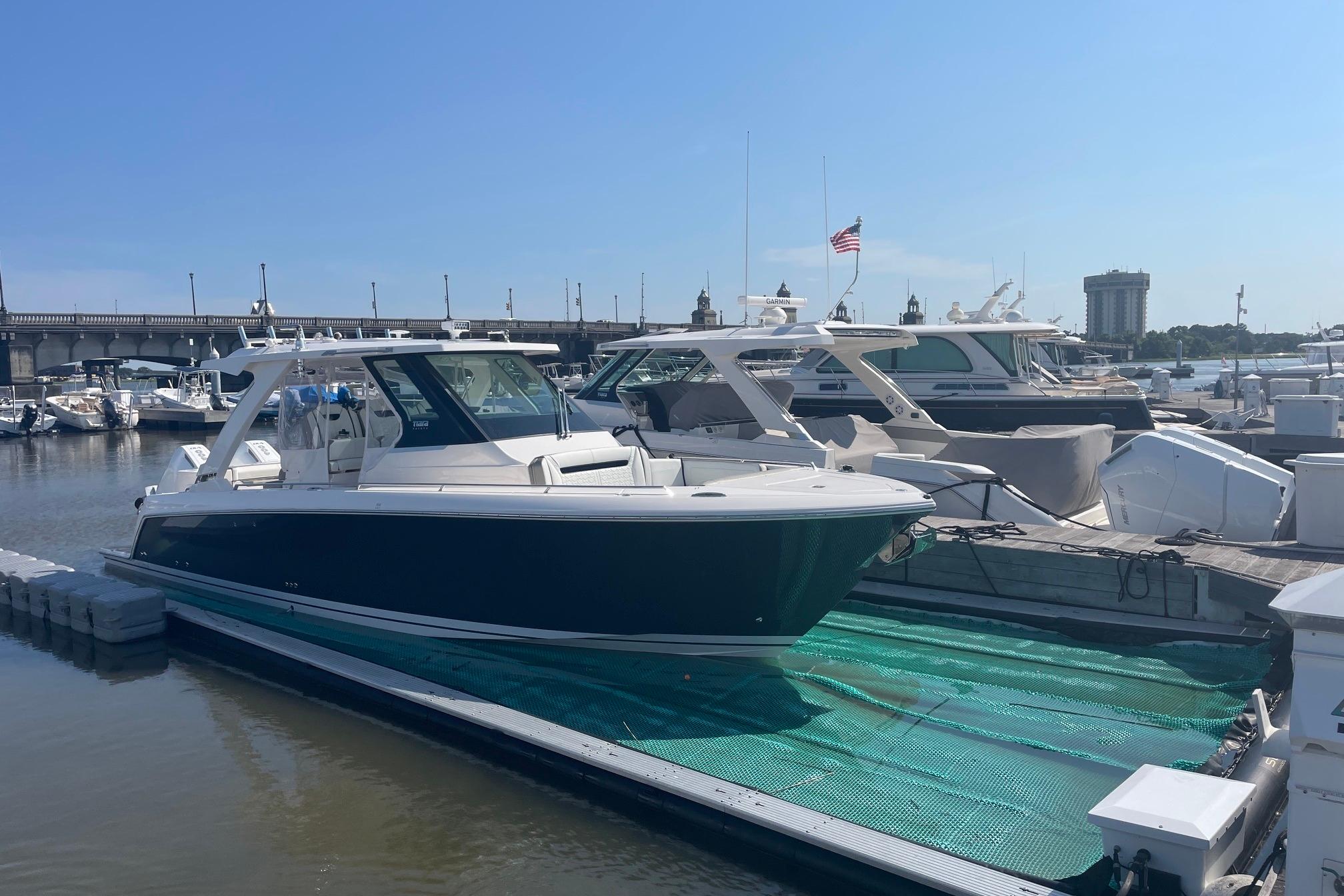 2024 Tiara Yachts 34 LS docked at a marina under clear blue skies.