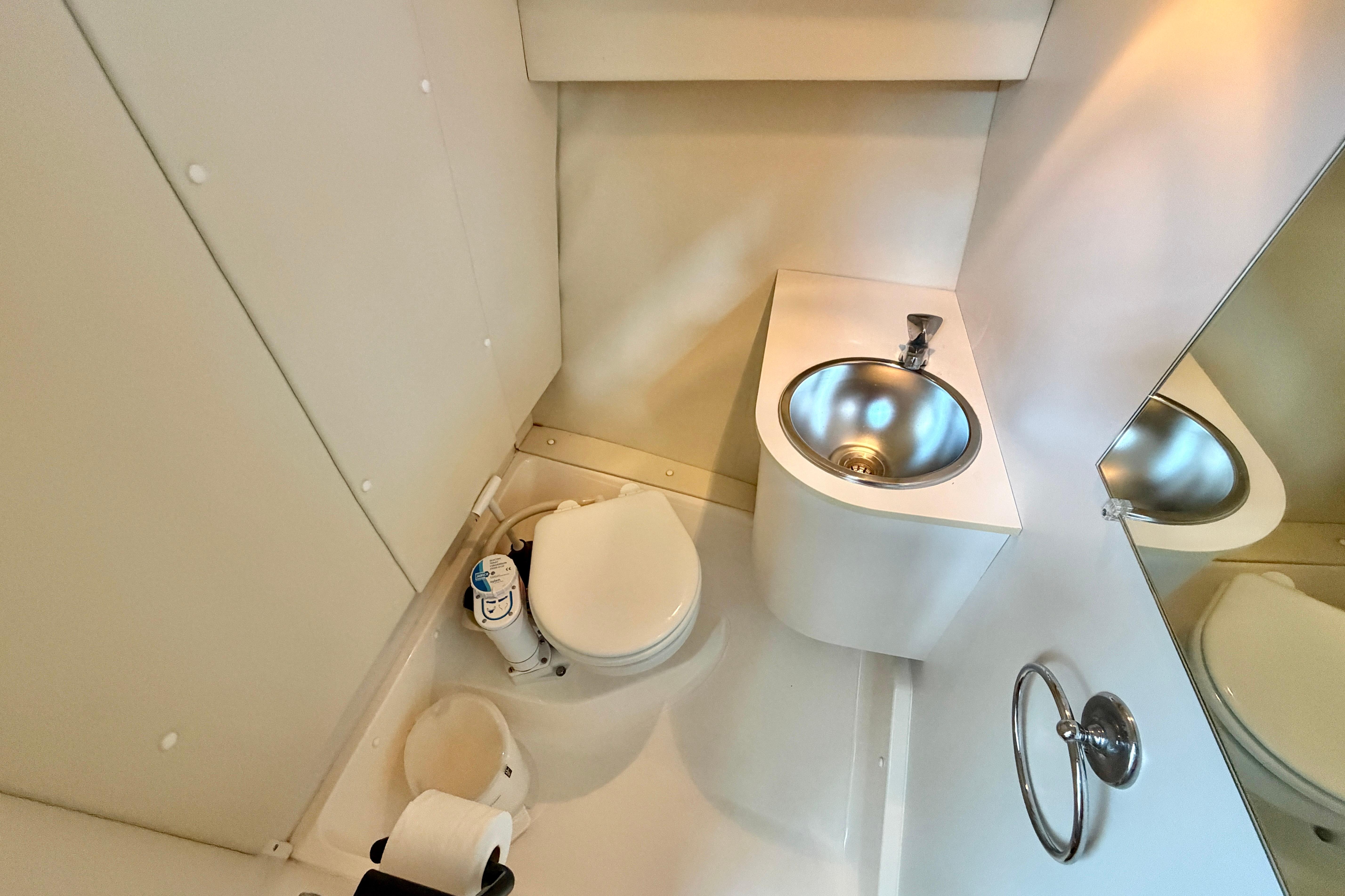 1999 Tiara Yachts 2900 Coronet bathroom with compact sink and toilet.