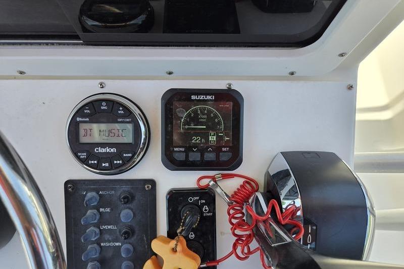 Control panel of a 2000 May-Craft 2000CC boat with Suzuki and Clarion displays.