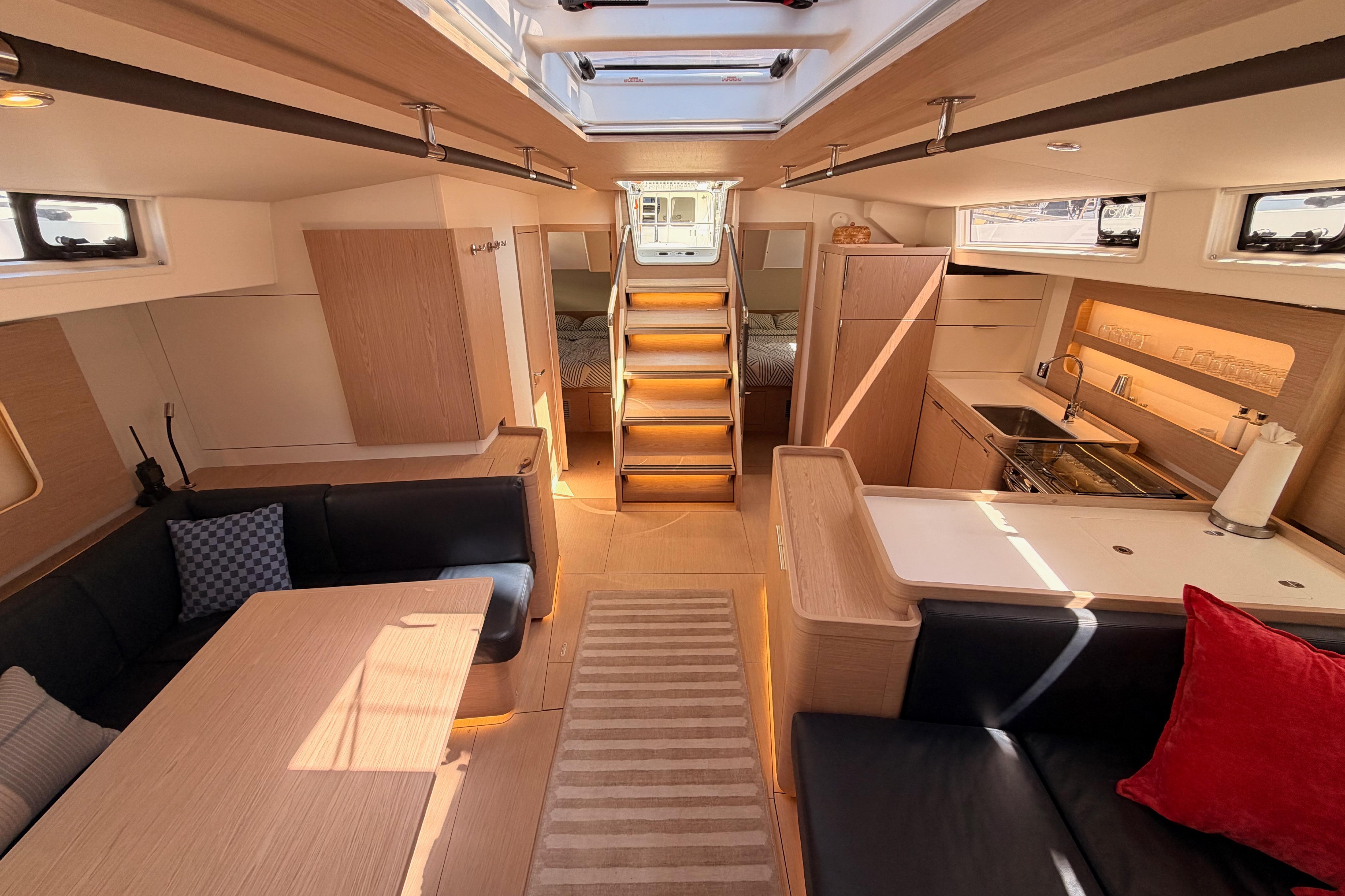 Luxurious interior of 2022 Beneteau Oceanis Yacht 54, featuring modern kitchen and seating area.