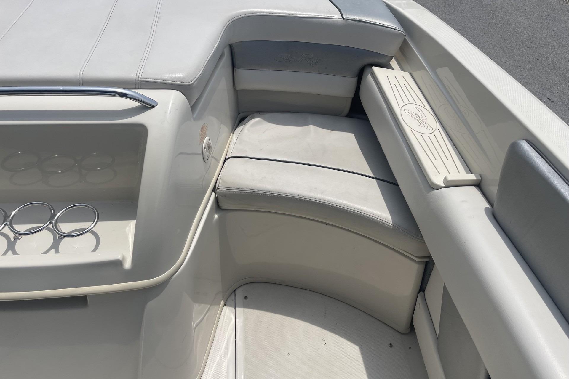 Interior seating of a 2010 Sea Ray 230 Bow Rider Select boat, featuring cup holders.