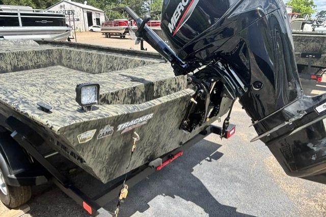 2026 Tracker Grizzly 1860 Utility boat with camouflage design and Mercury outboard motor.