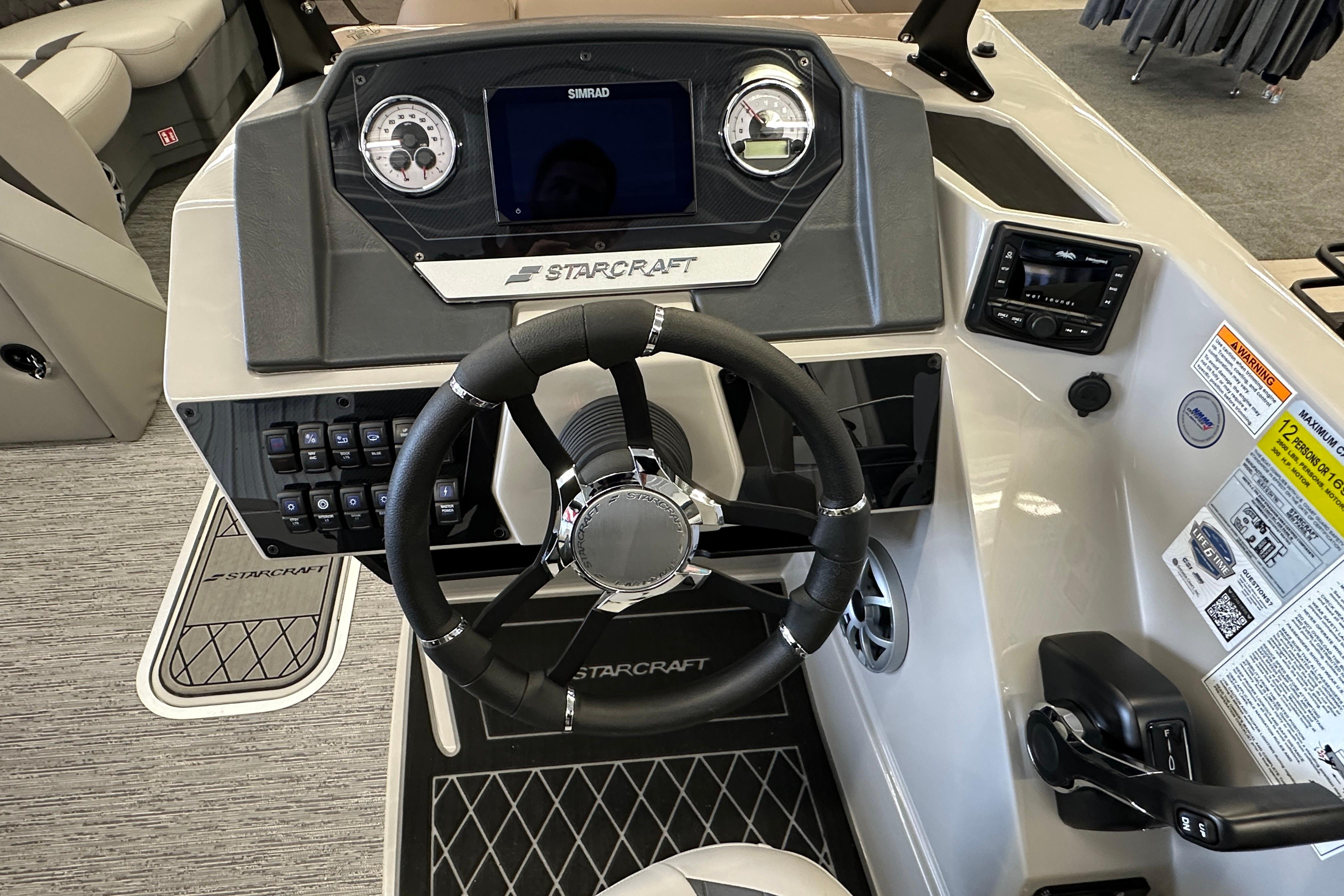 2026 Starcraft SLS 3 Q DH boat dashboard with steering wheel and control panel.