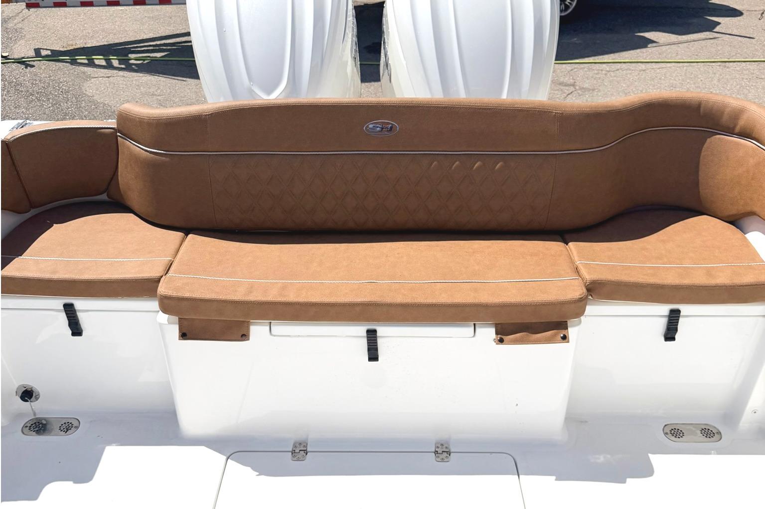 2026 Seahunt Ultra 305 CB boat with tan cushioned seating and white exterior.