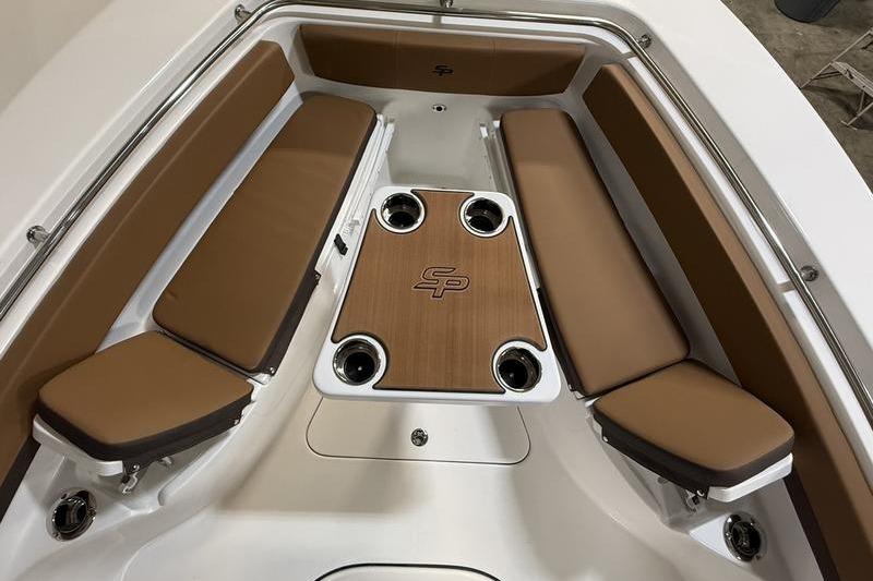 2026 Sea Pro 242 Center Console boat interior with cushioned seating and table.