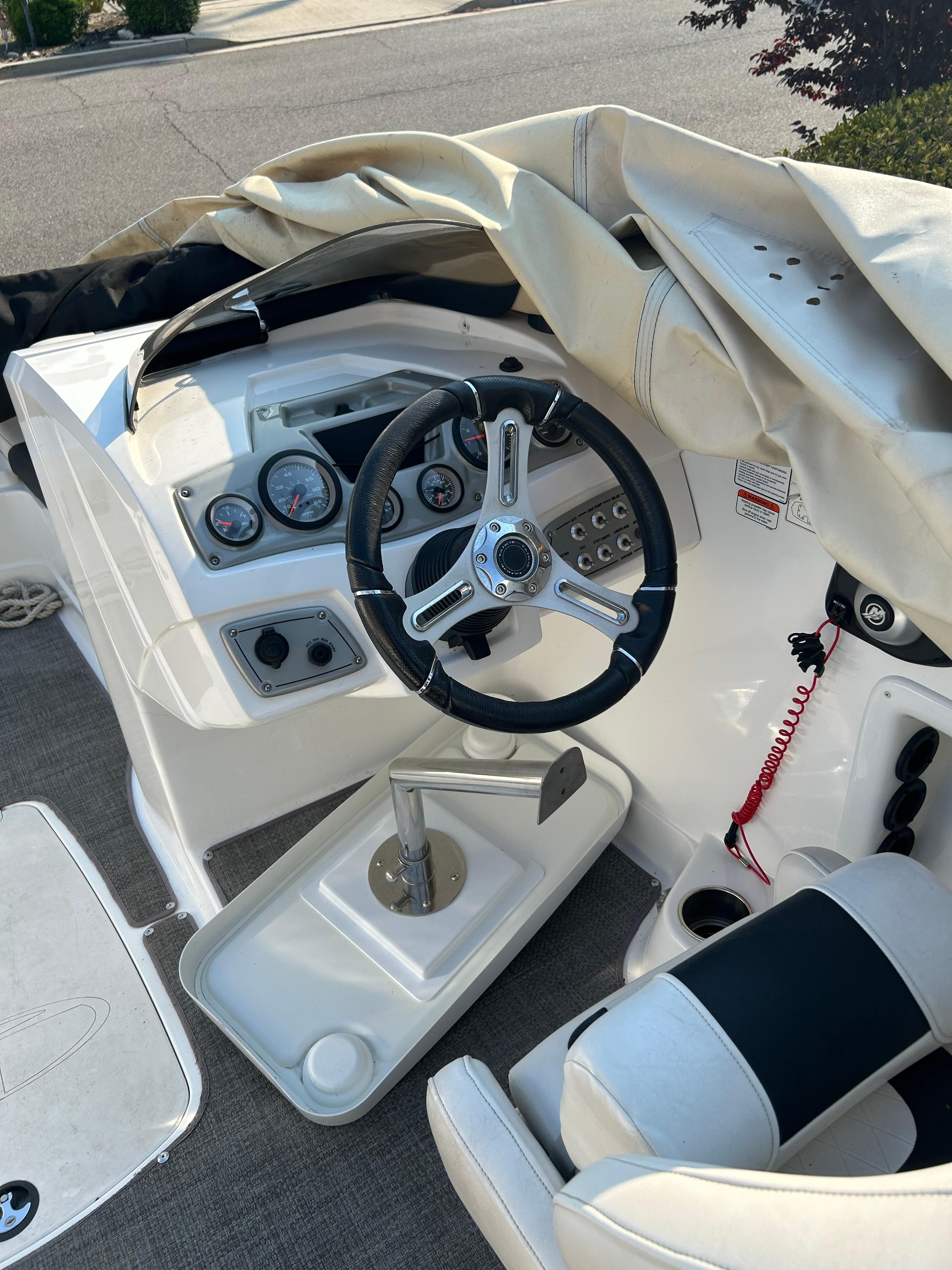 The image shows the cockpit of a 2017 Tracker TAHOE 2150 boat with steering wheel and instruments.