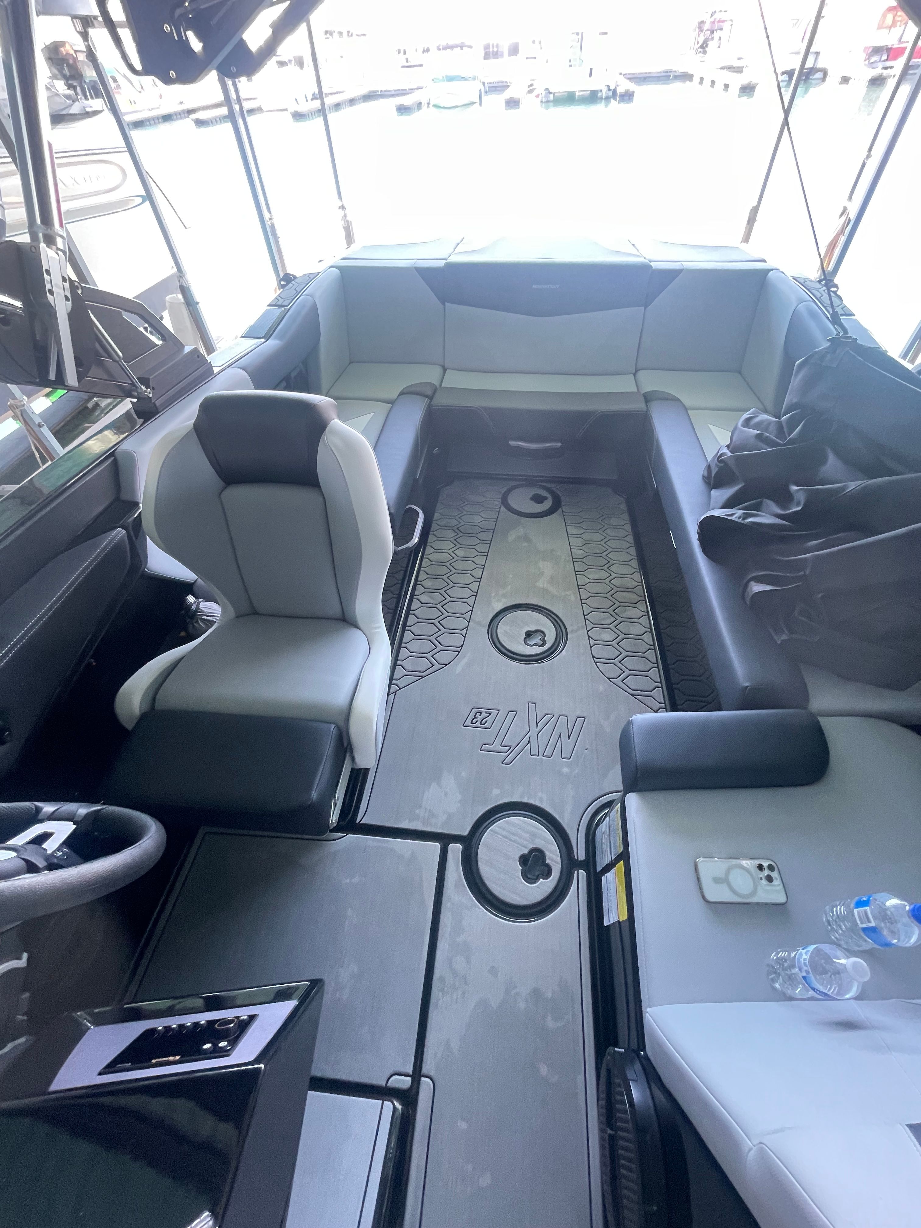Interior of a MasterCraft NXT23 boat with gray seating and modern design.