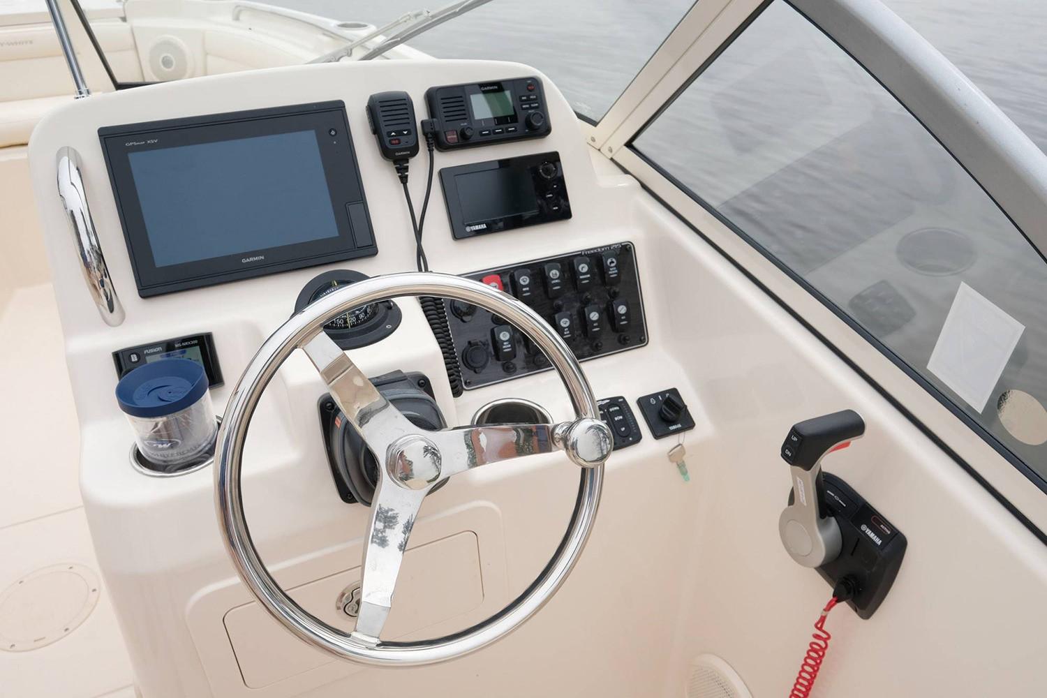 Manufacturer Provided Image: 2019 Grady-White Freedom 215 boat dashboard with steering wheel and electronic controls.