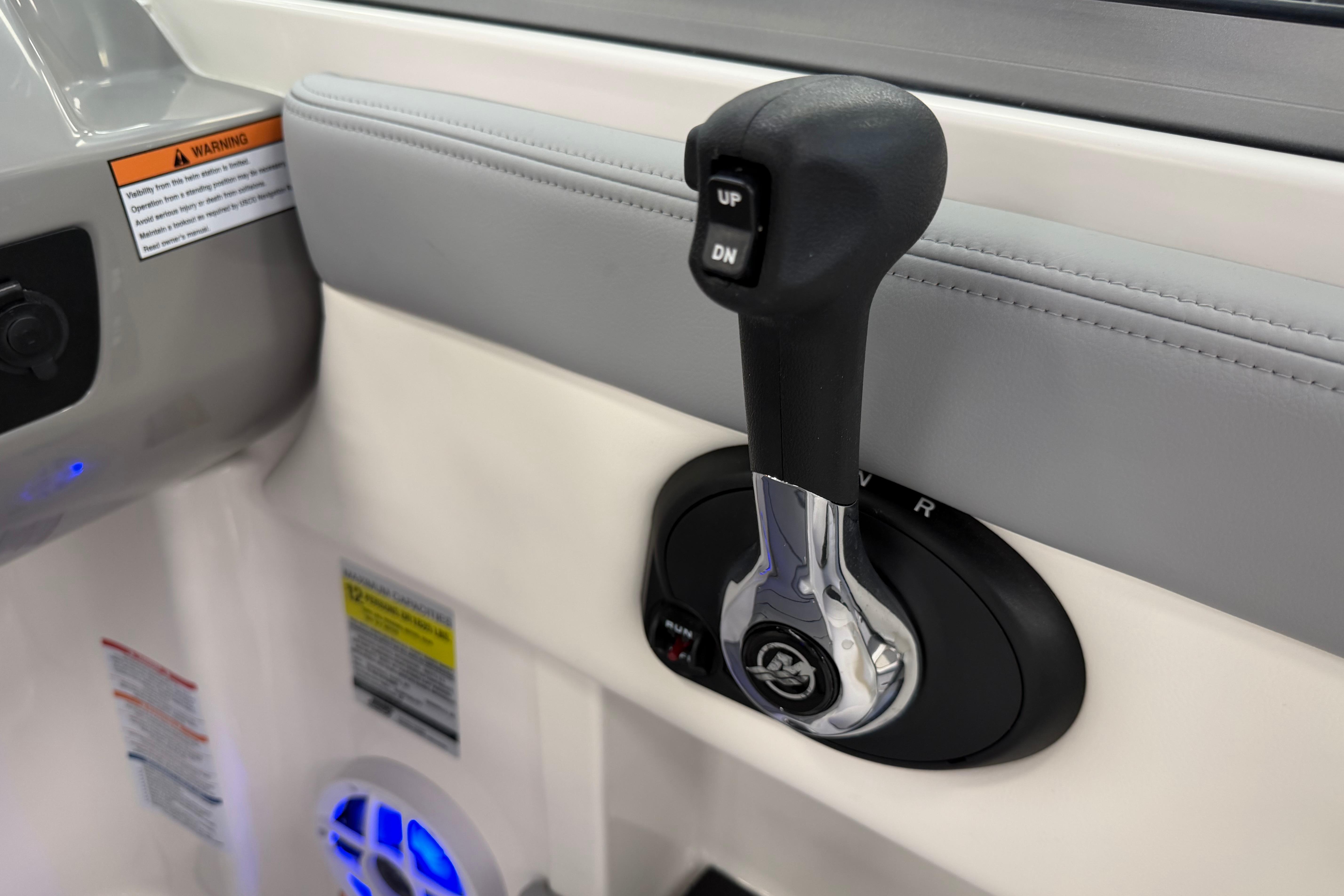 Throttle control lever on 2025 Chaparral 21 SSi OB boat interior.
