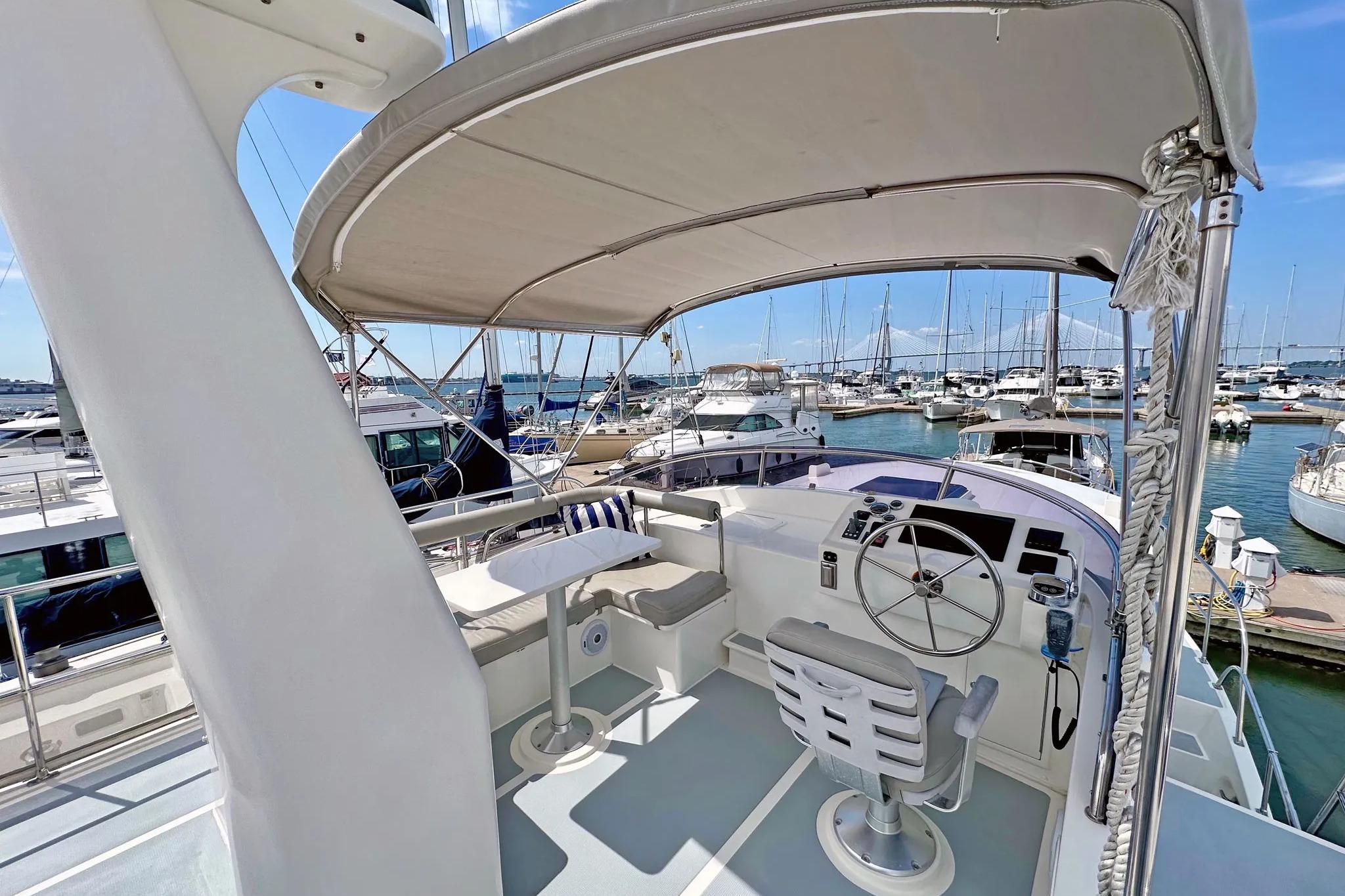 Helmsman Trawlers 38 Pilothouse 2016, featuring a spacious helm and marina view.