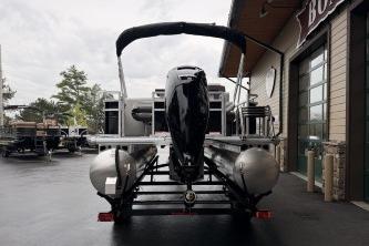 2026 Sun Tracker Fishin' Barge 20 DLX pontoon boat, rear view, parked outdoors.