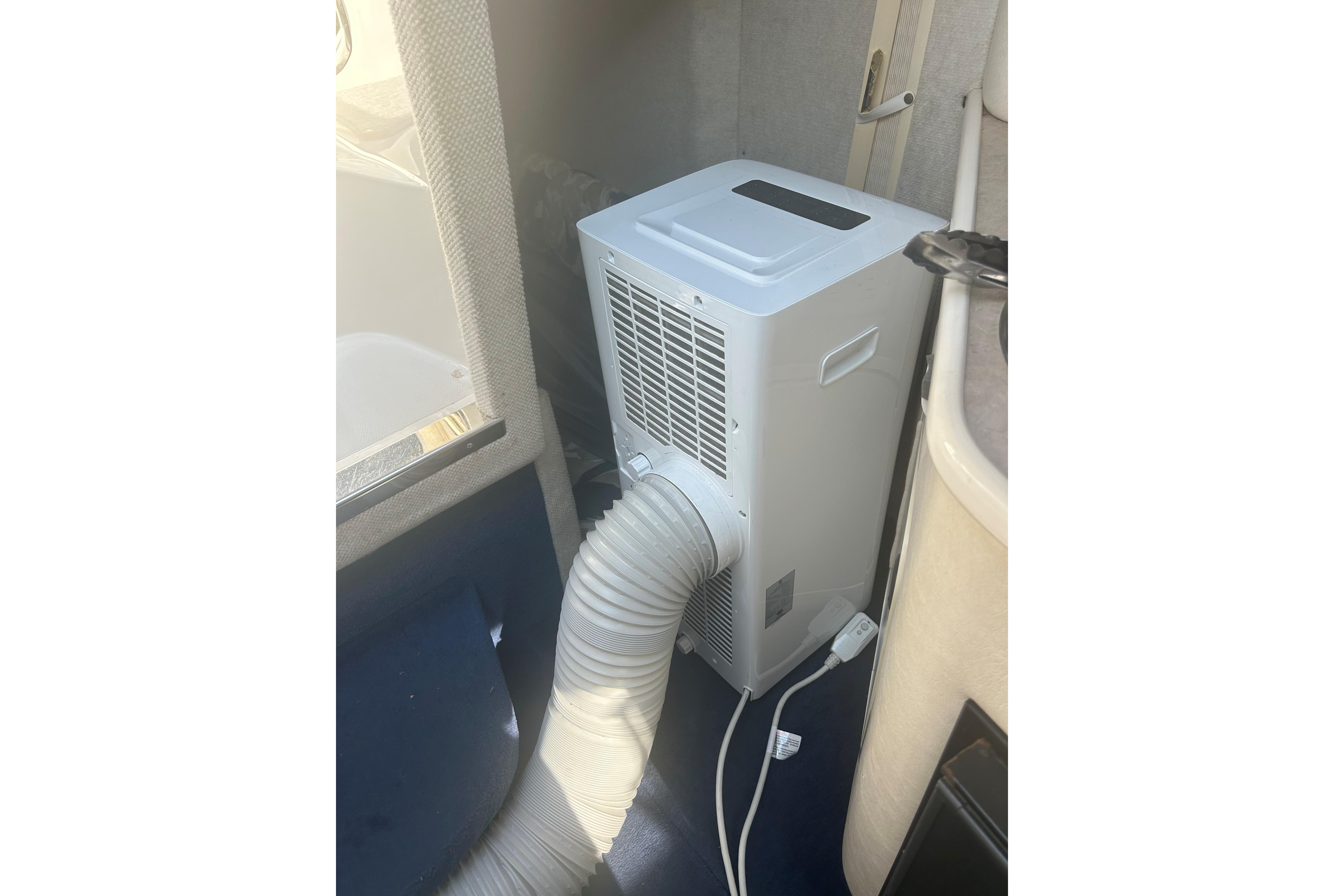 Portable air conditioner inside a 2000 Sea Ray 240 Sundancer boat cabin.