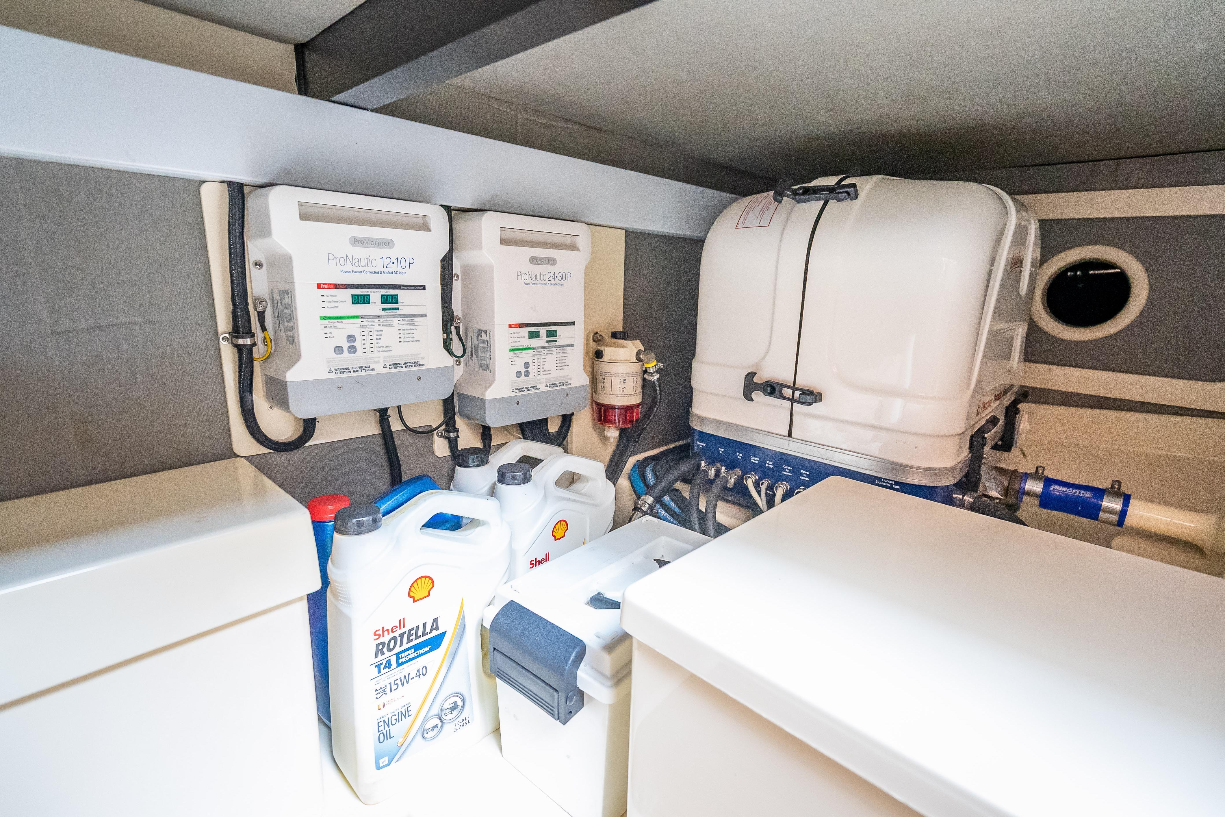 Engine room of 2018 Palm Beach Motor Yachts PB50 with equipment and oil containers.