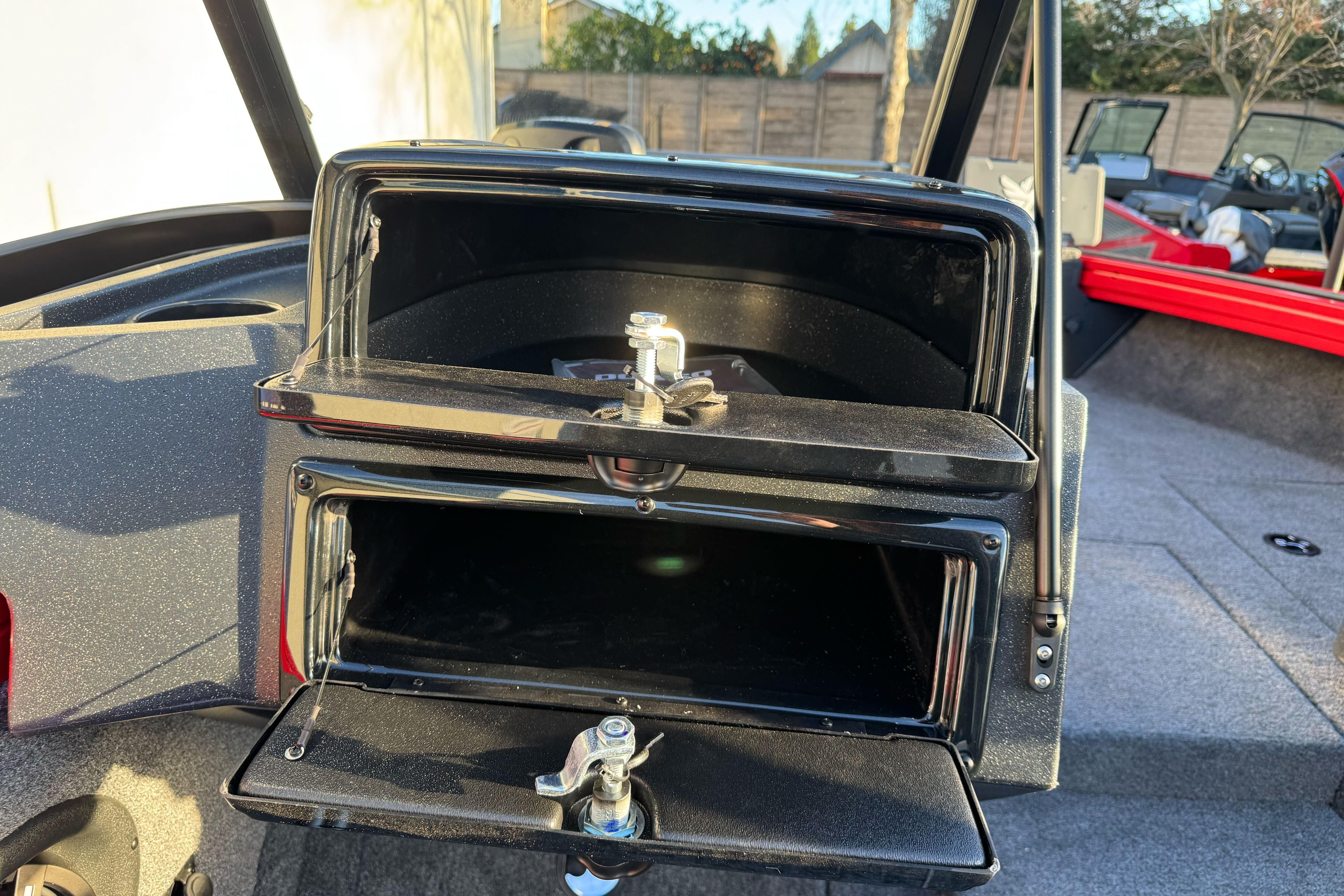 2026 Tracker Targa V-18 WT boat storage compartments, open and empty, with visible latches.