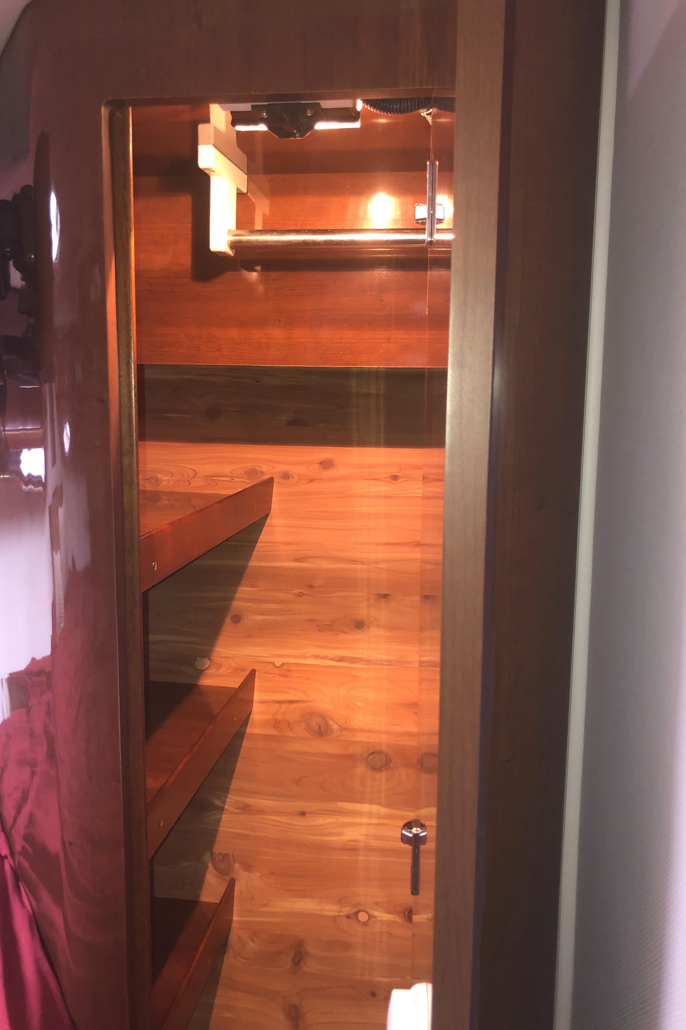 Interior of 2018 Four Winns V355 yacht with wooden shelves and warm lighting.