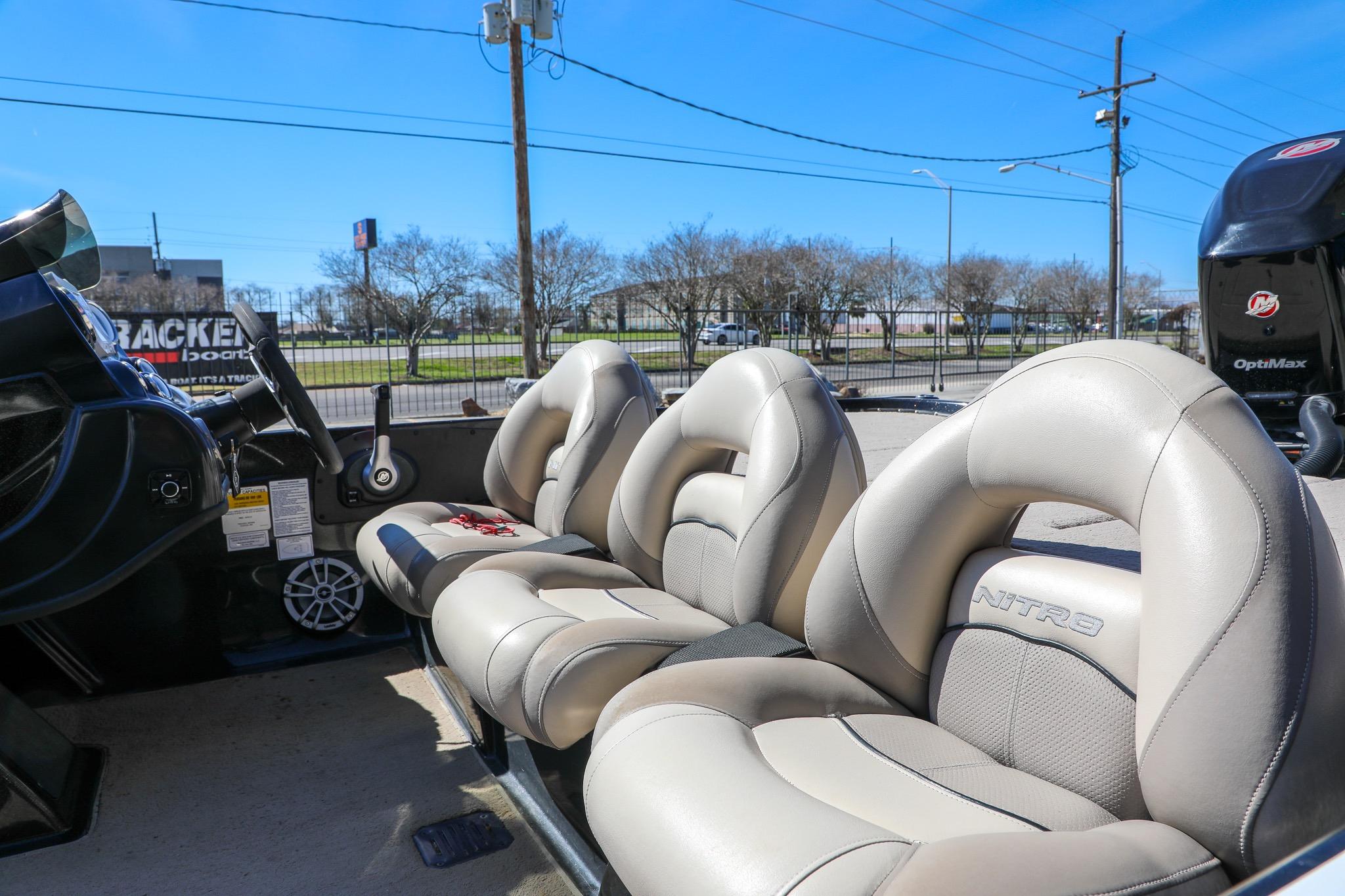 2013 Nitro Z-7 boat interior with beige seats and steering wheel.
