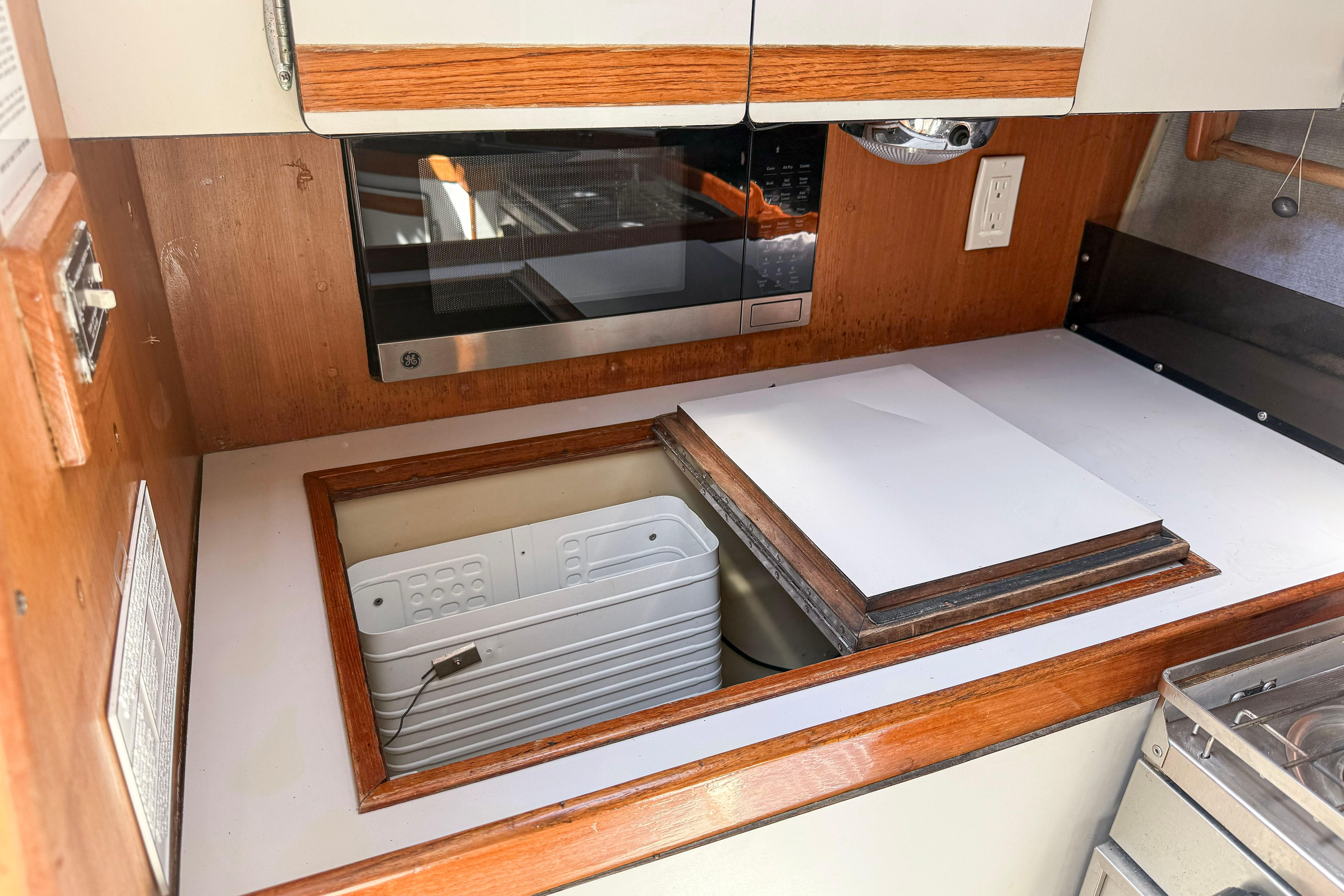 1988 Oday 40 yacht kitchen with microwave and storage compartments.