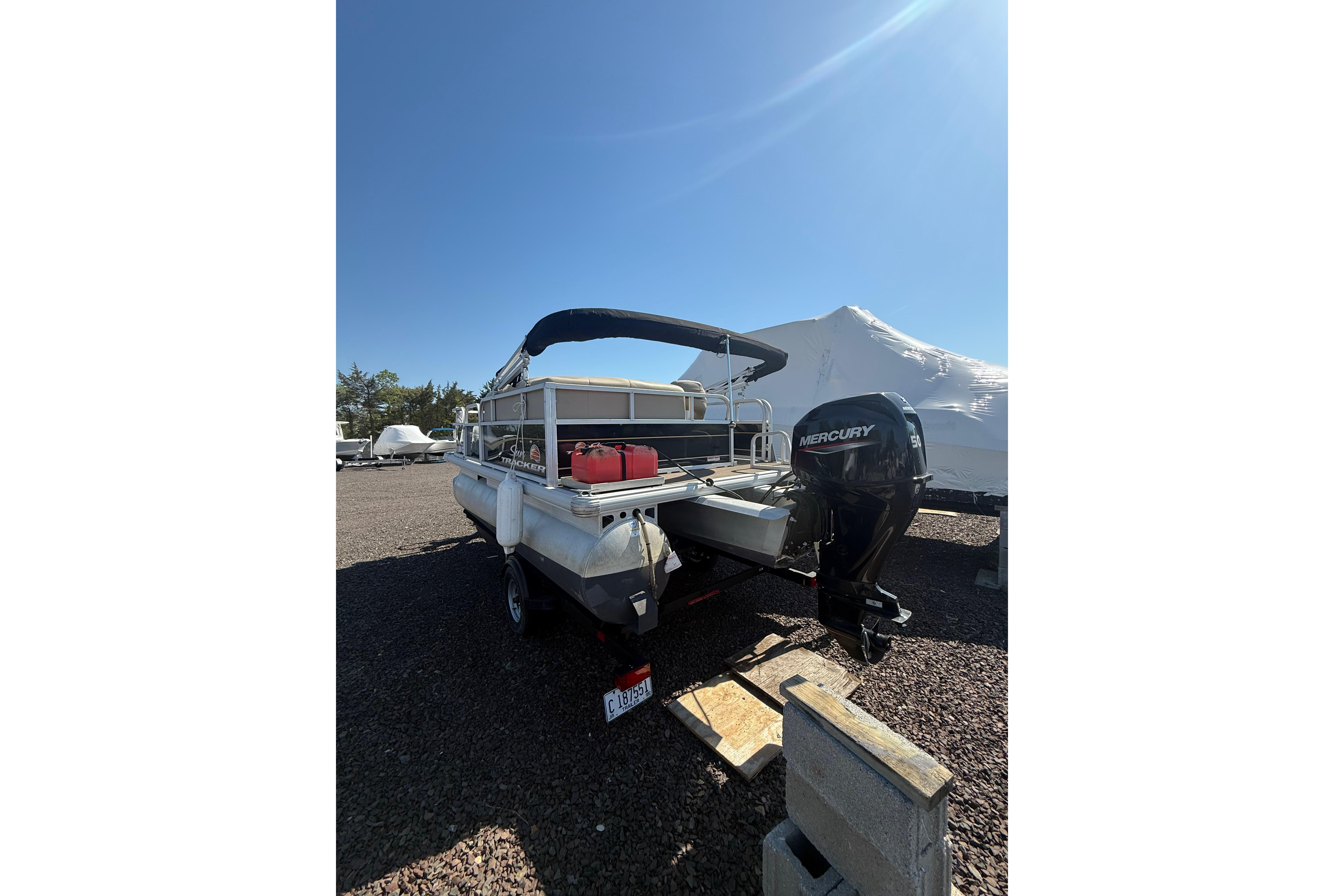 2021 Sun Tracker Bass Buggy 16 XL Select pontoon boat with Mercury outboard motor.