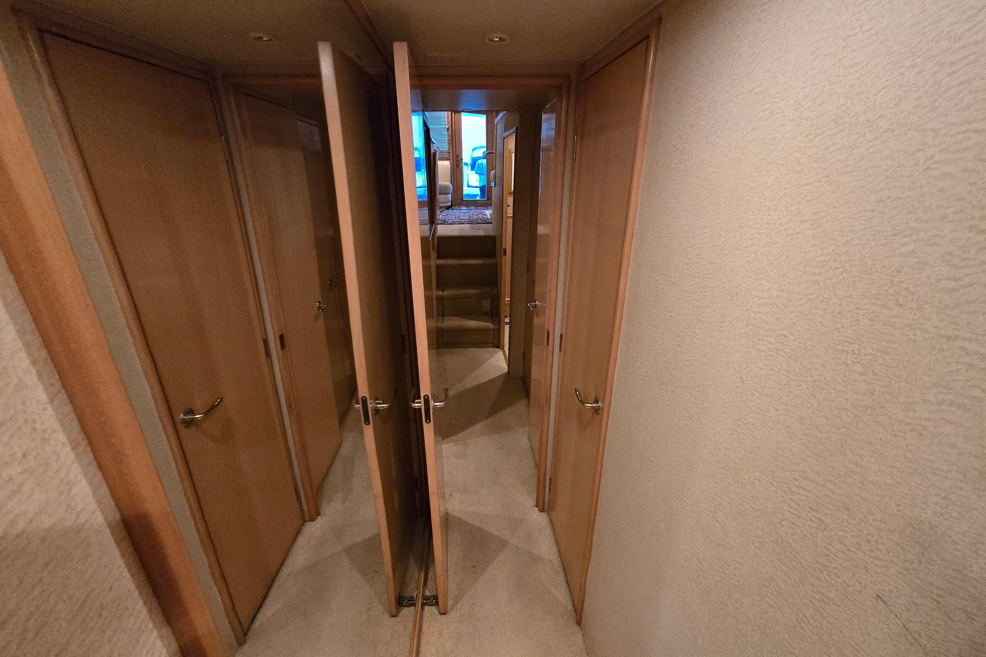 Interior hallway of 2001 Cavileer 53 Convertible yacht with wooden doors and carpeted floor.