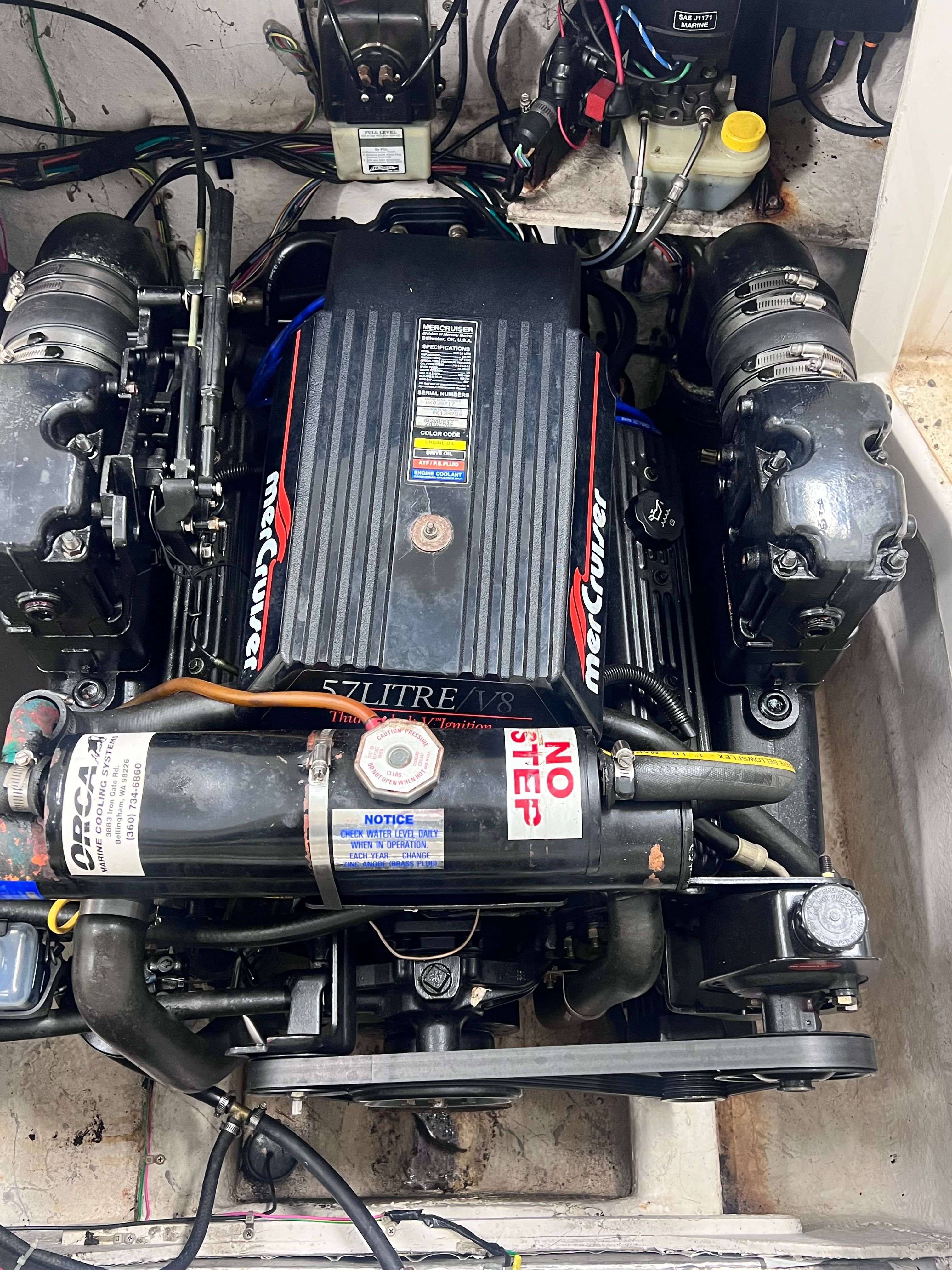 Engine compartment of a 1997 Bayliner 2452 with MerCruiser 5.7L V8 engine.