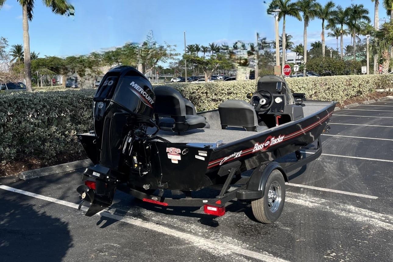 2026 Tracker Bass Tracker Classic XL boat in parking lot, featuring Mercury engine.