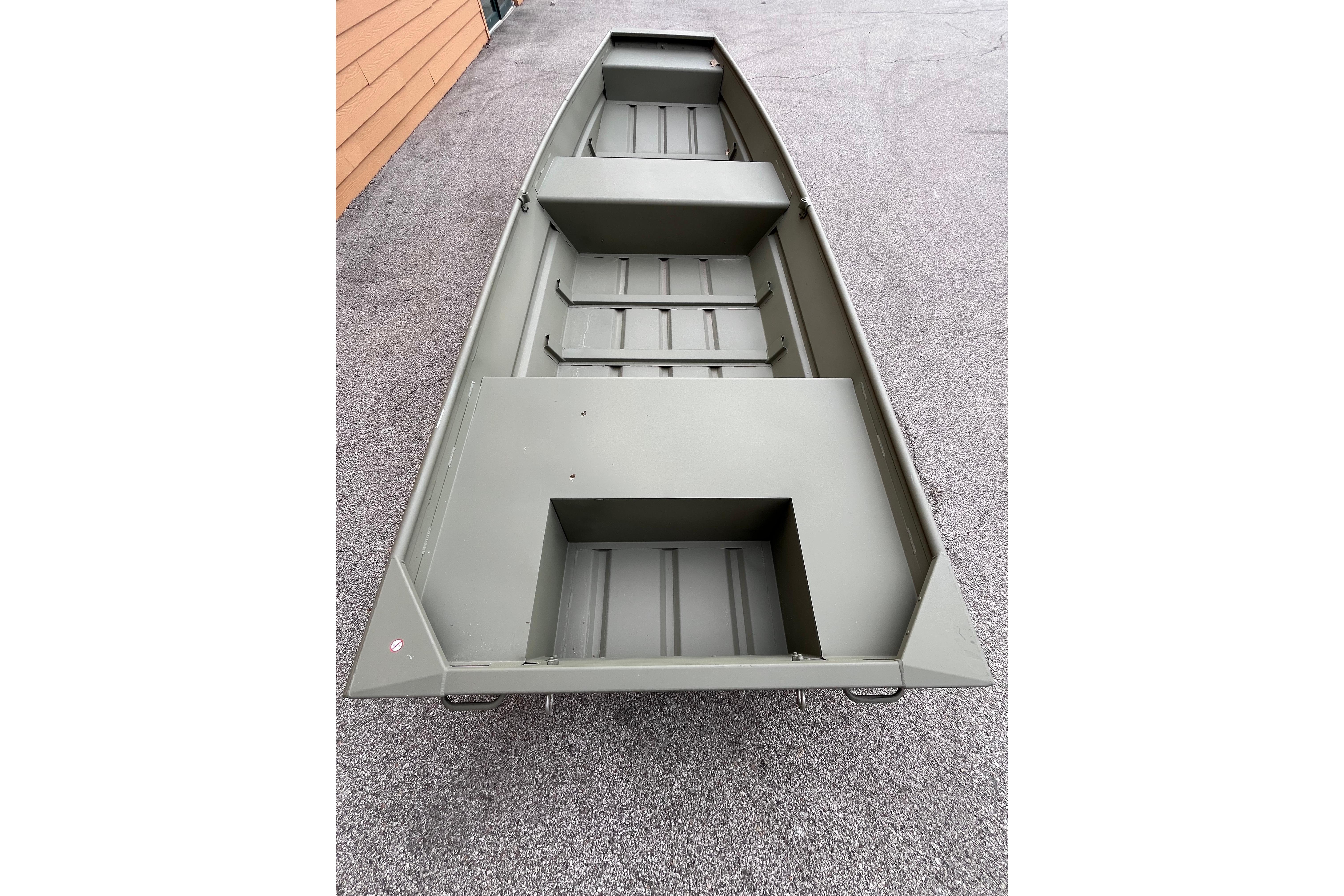2026 Tracker Grizzly 14 Jon boat, olive green, on a paved surface.