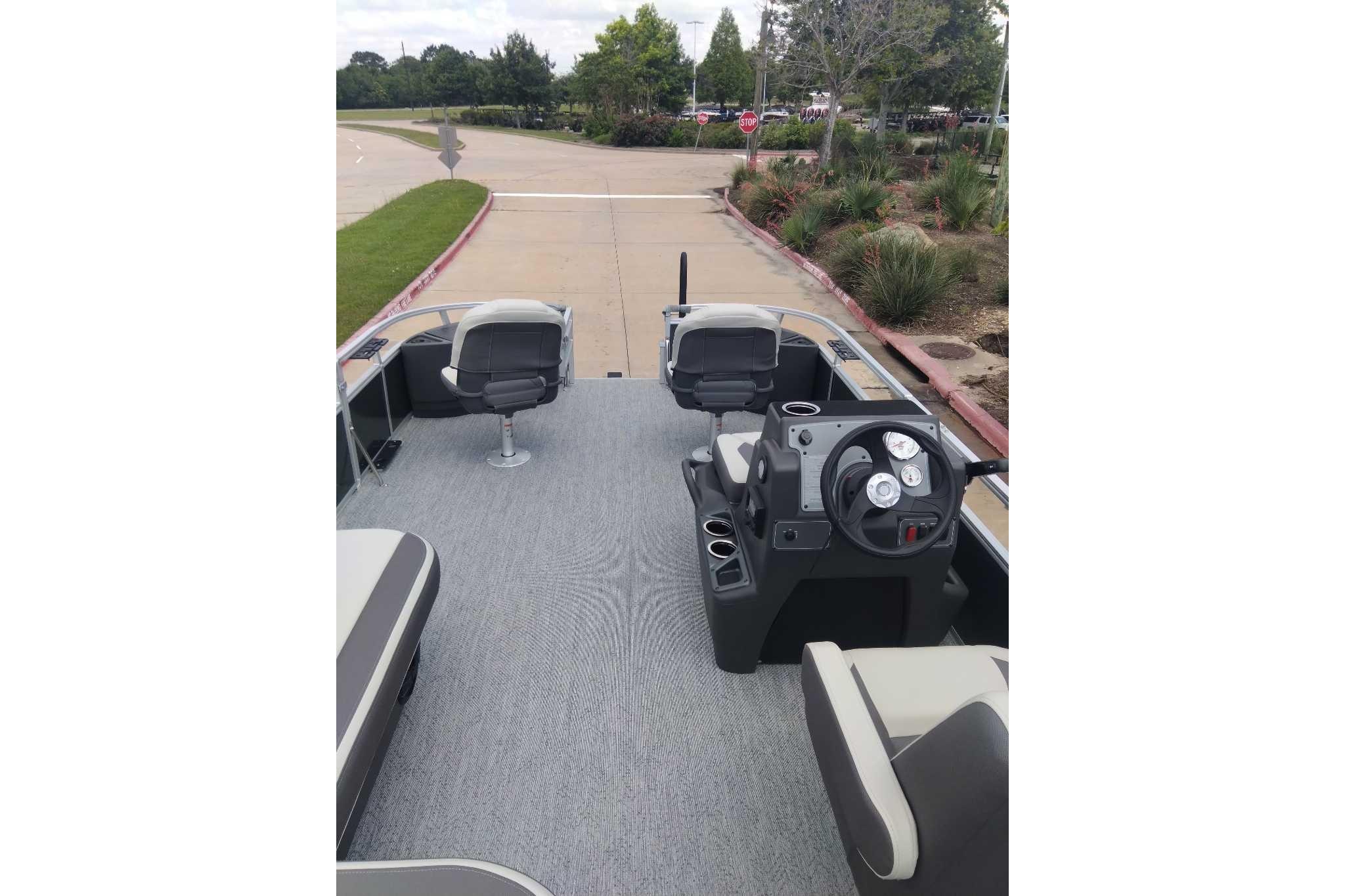 2026 Sun Tracker Bass Buggy 18 DLX pontoon boat interior with seating and steering console.