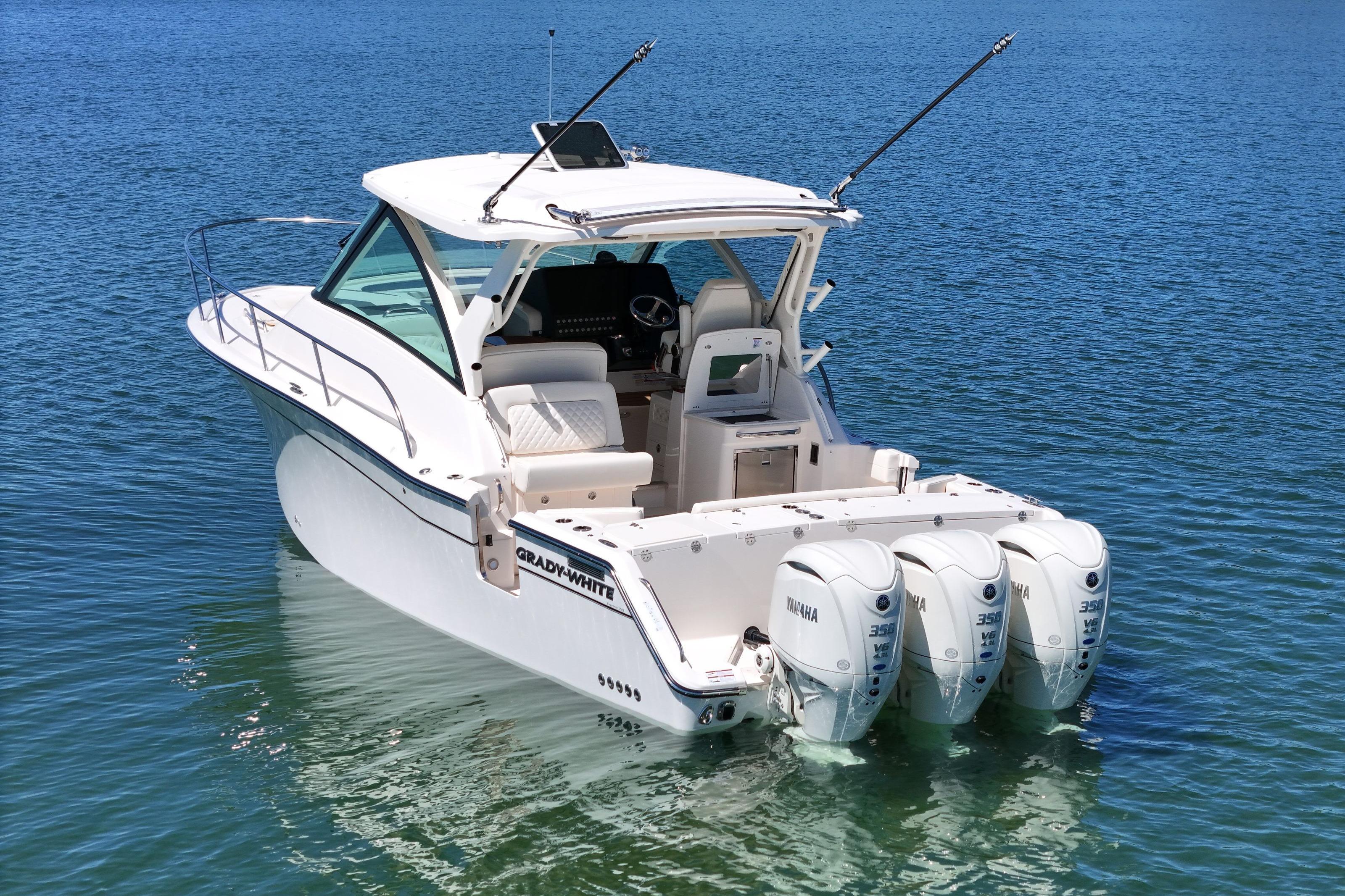 2026 Grady-White Express 340 boat with triple Yamaha engines on calm water.