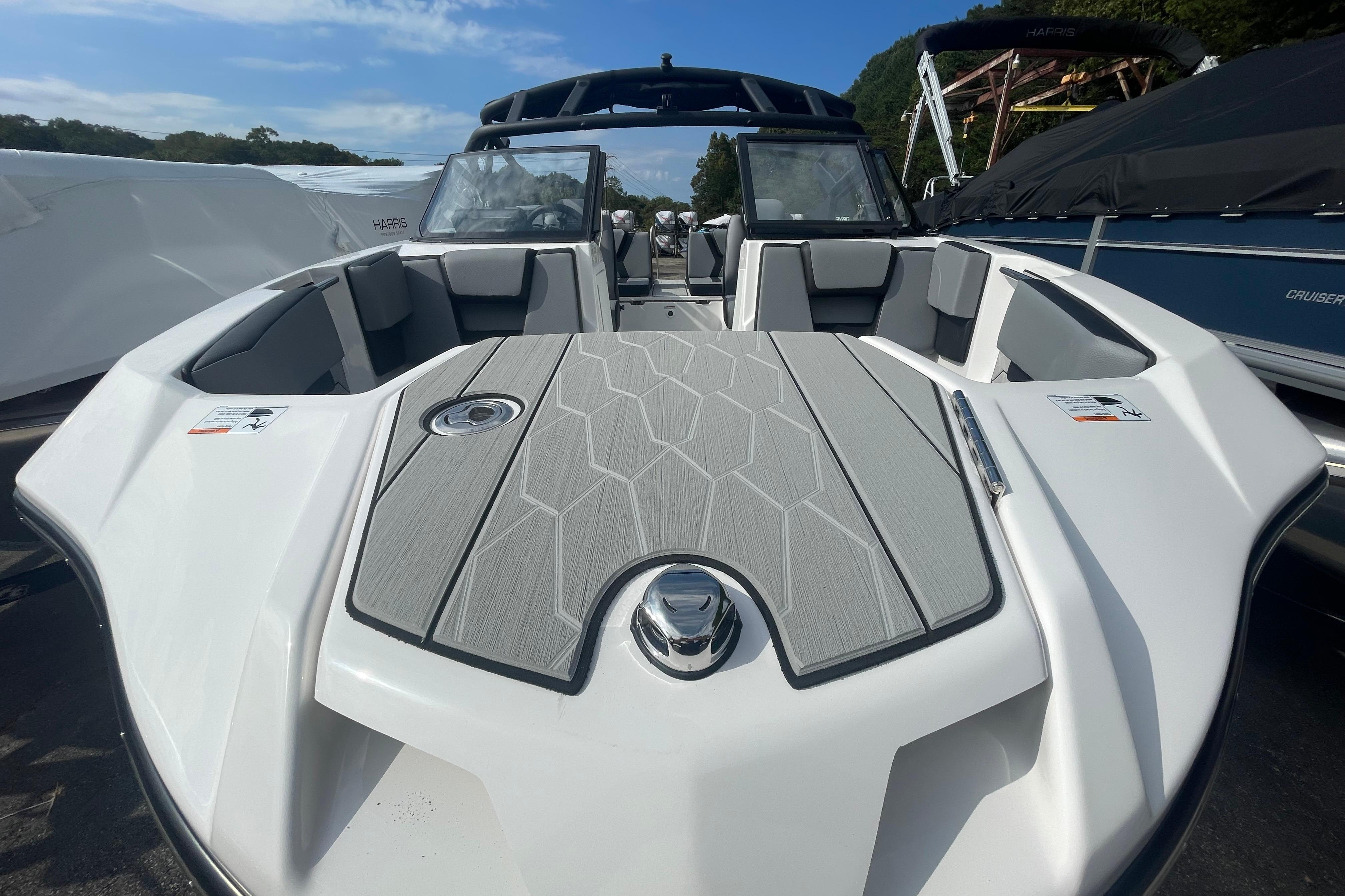 2026 Yamaha Boats 222XD, sleek design, spacious seating, modern features, docked under clear sky.