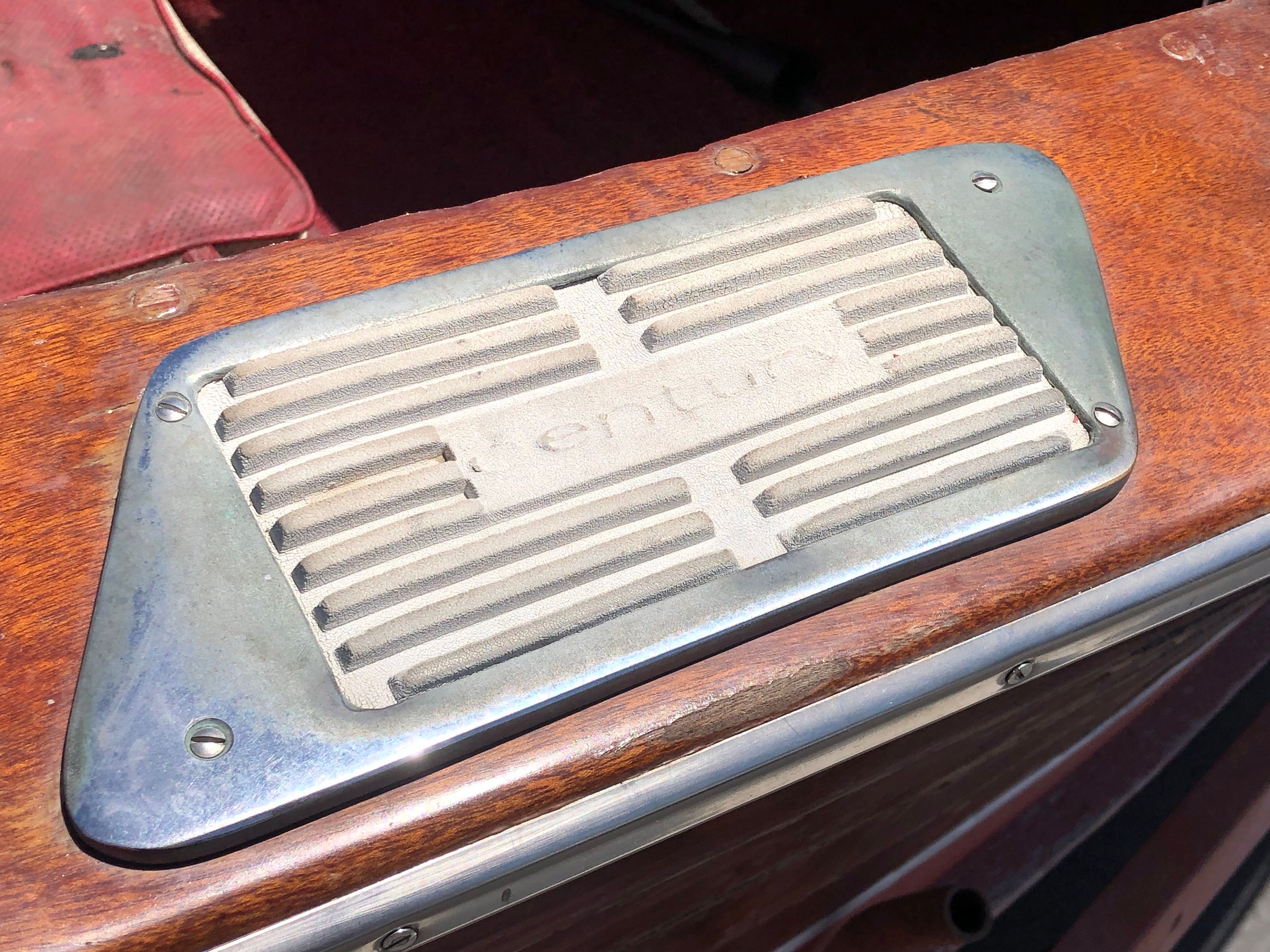 Close-up of a 1960 Century Resorter featuring a metal grille on wood.