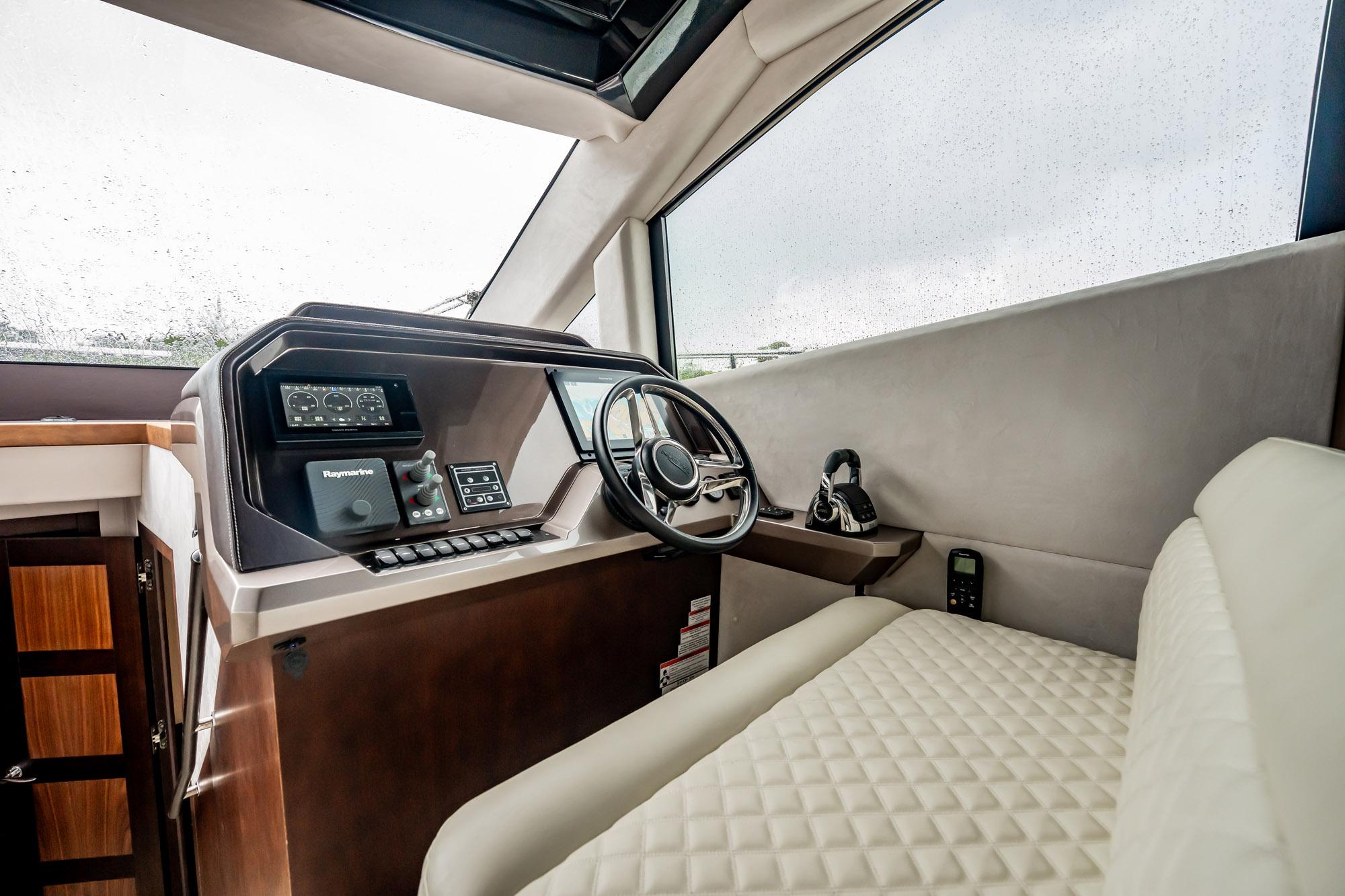 Interior helm of 2017 Galeon 510 Sky yacht with modern controls and steering wheel.