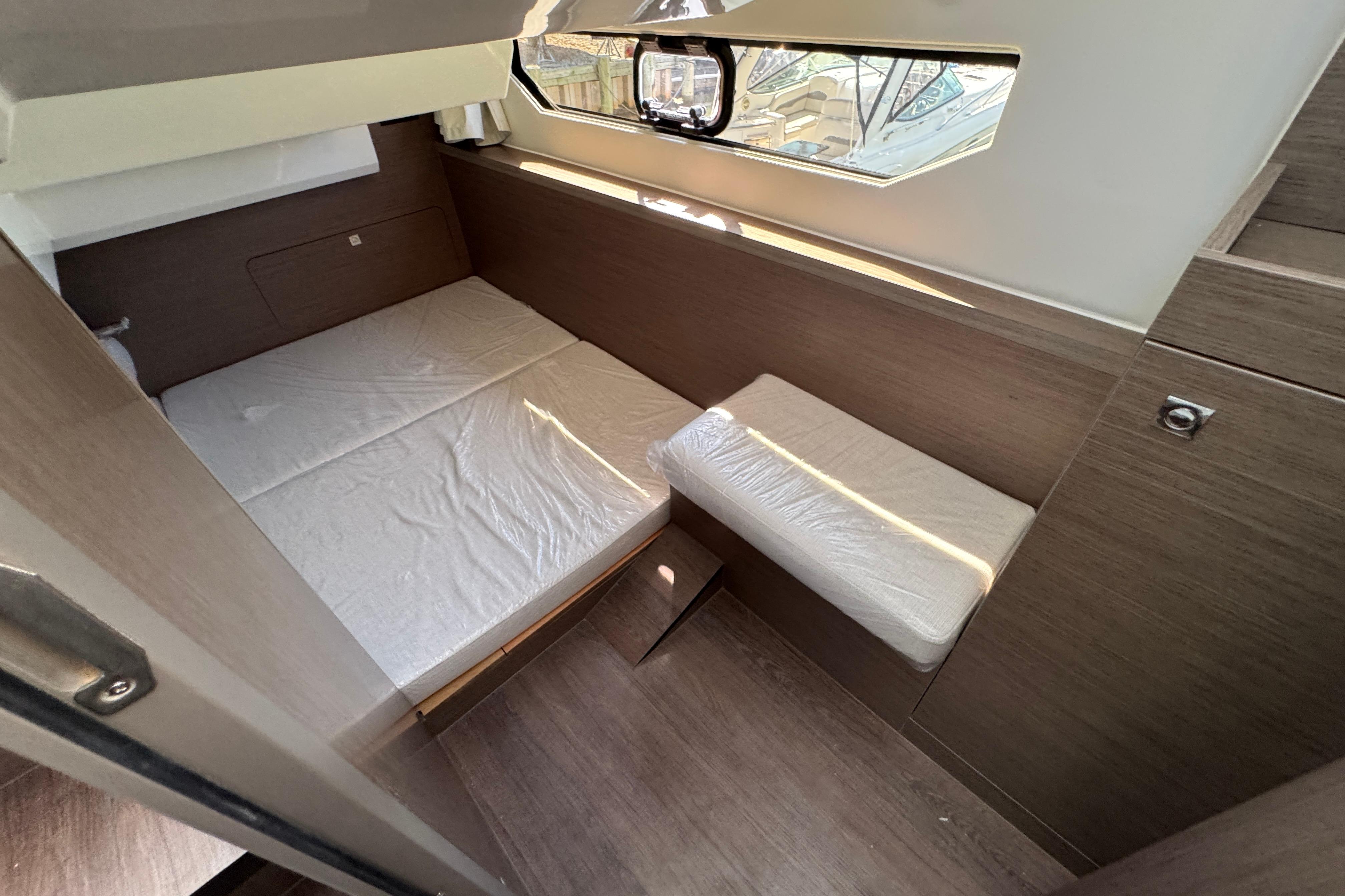 2026 Jeanneau NC 895 Series 2 cabin interior with bed and window view.
