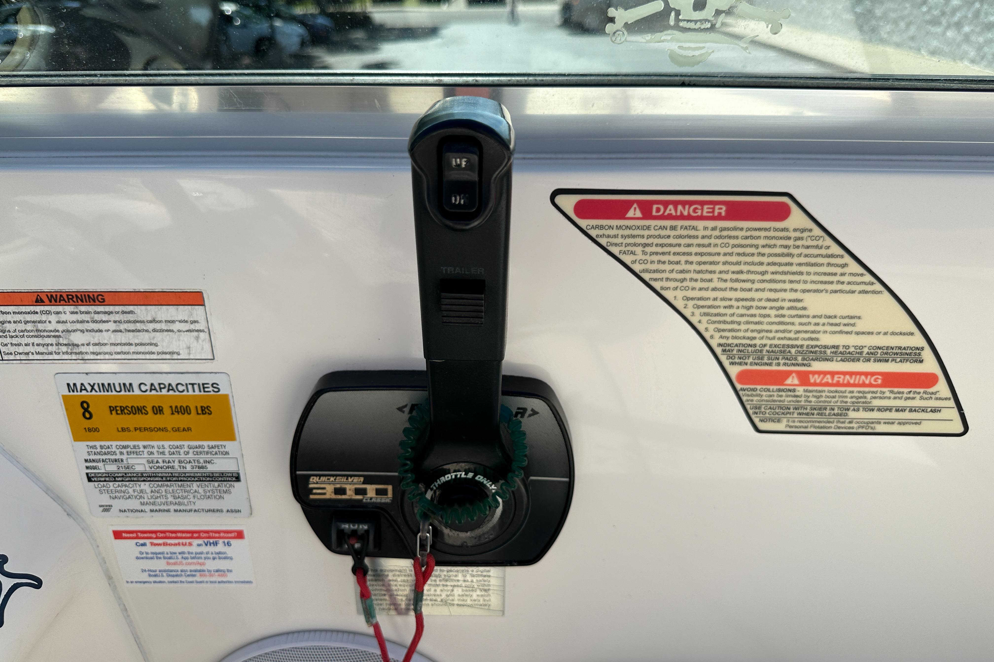 Control panel of a 1998 Sea Ray 215 Express Cruiser with safety warnings and capacity limits.