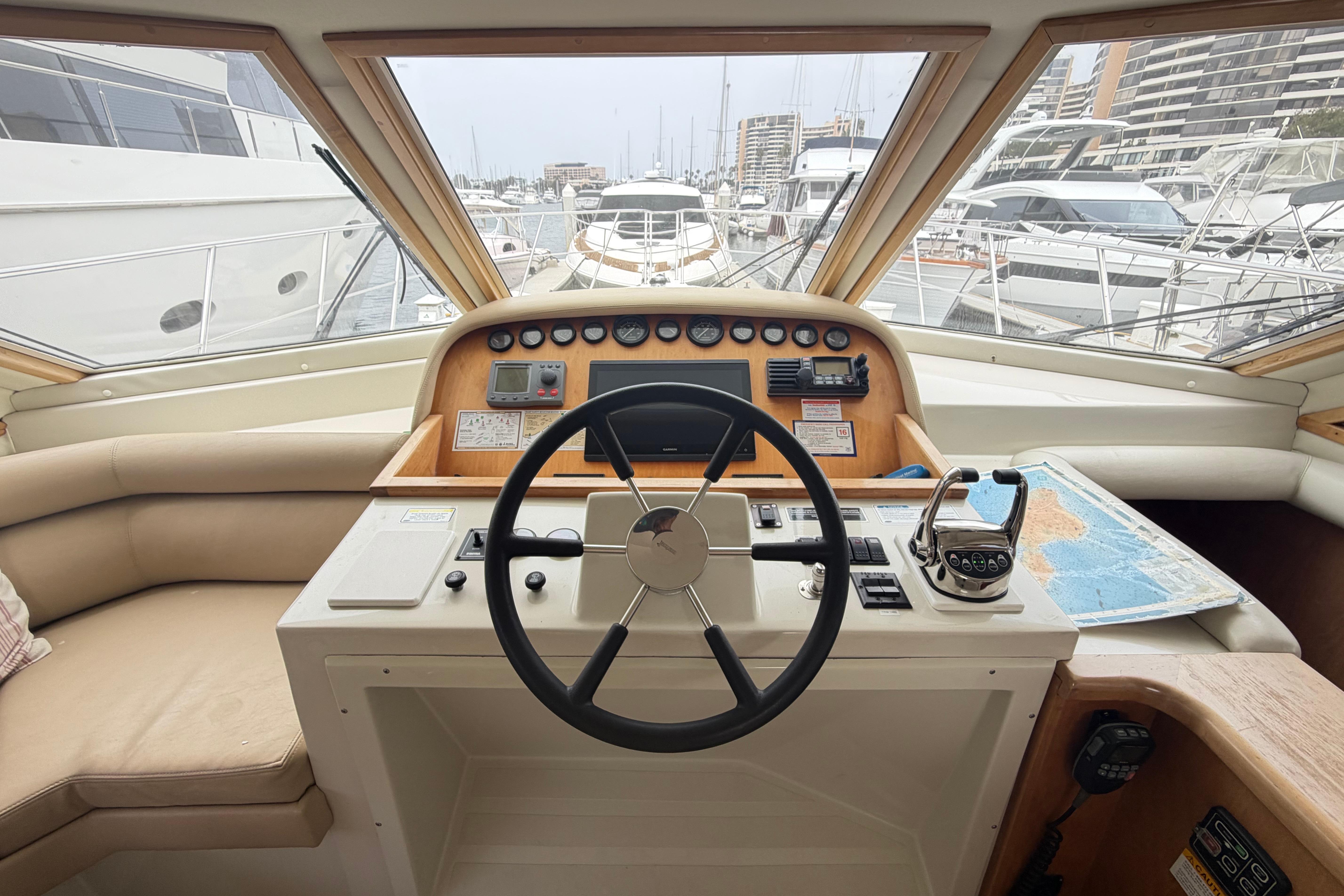 Pilot house interior of 2005 Navigator 53, featuring steering wheel and navigation controls.