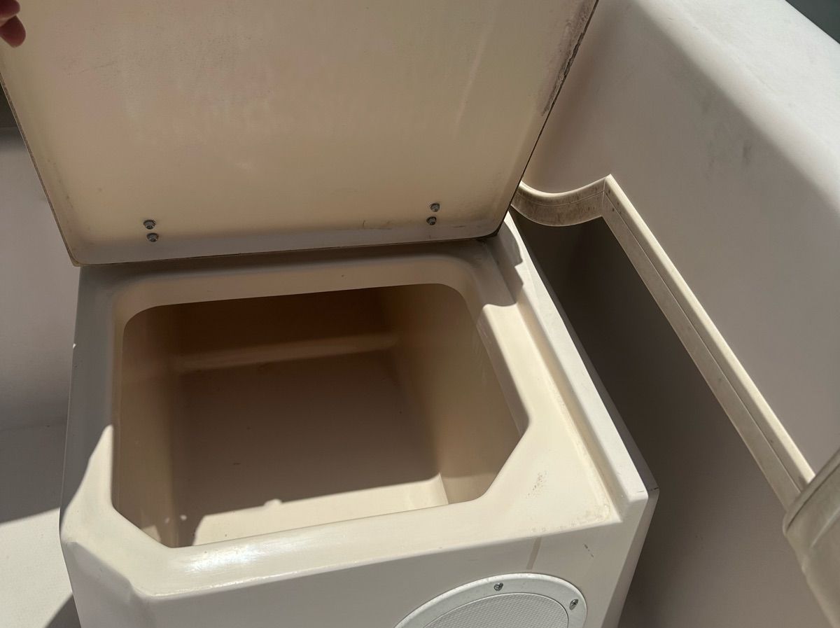 An open storage compartment on a boat with a light-colored interior.