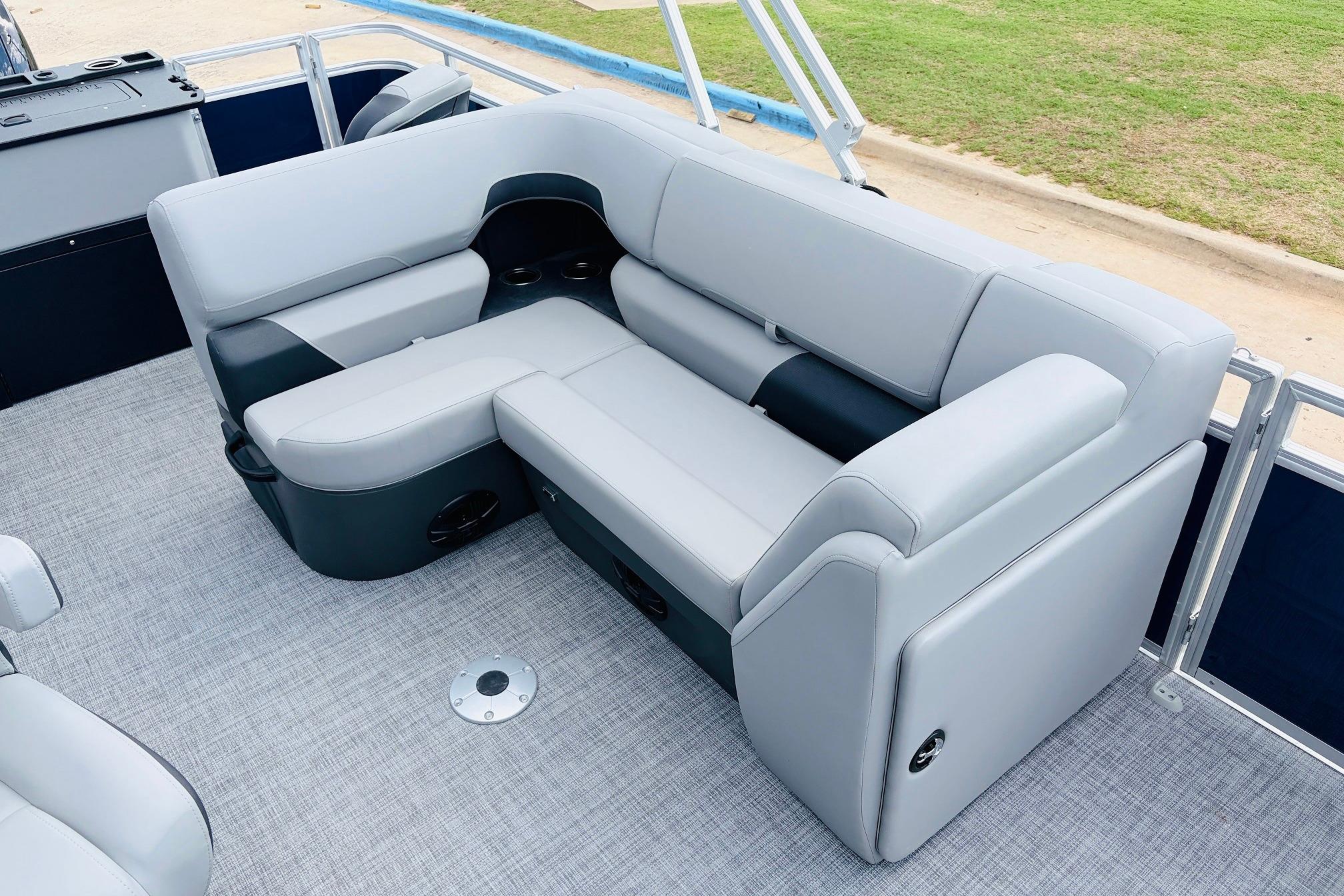 2026 Sun Tracker SportFish 22 DLX pontoon boat with plush gray seating and modern design.