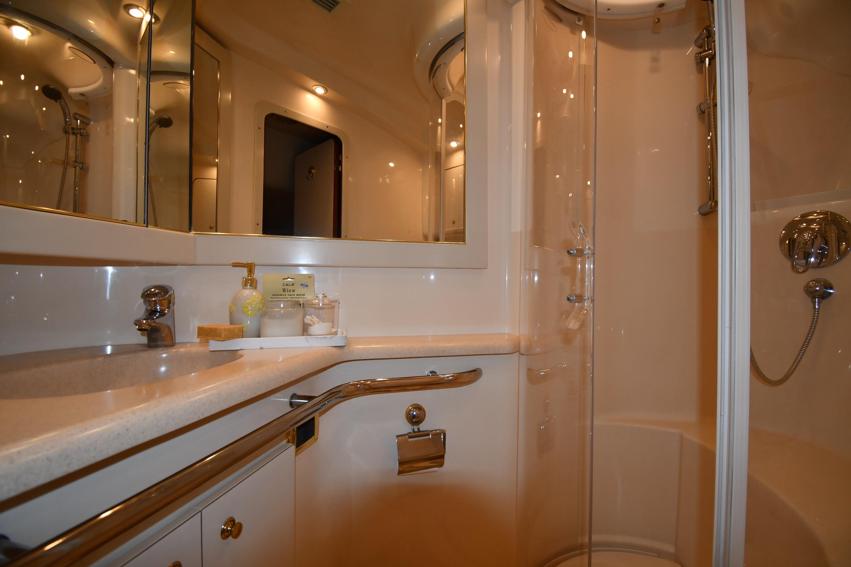 Luxurious bathroom in 2001 Sea Ray 540 Sundancer yacht with modern fixtures and shower.
