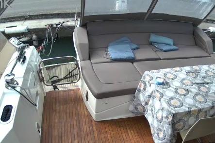2016 Prestige 550 yacht deck with seating, table, and folded towels.